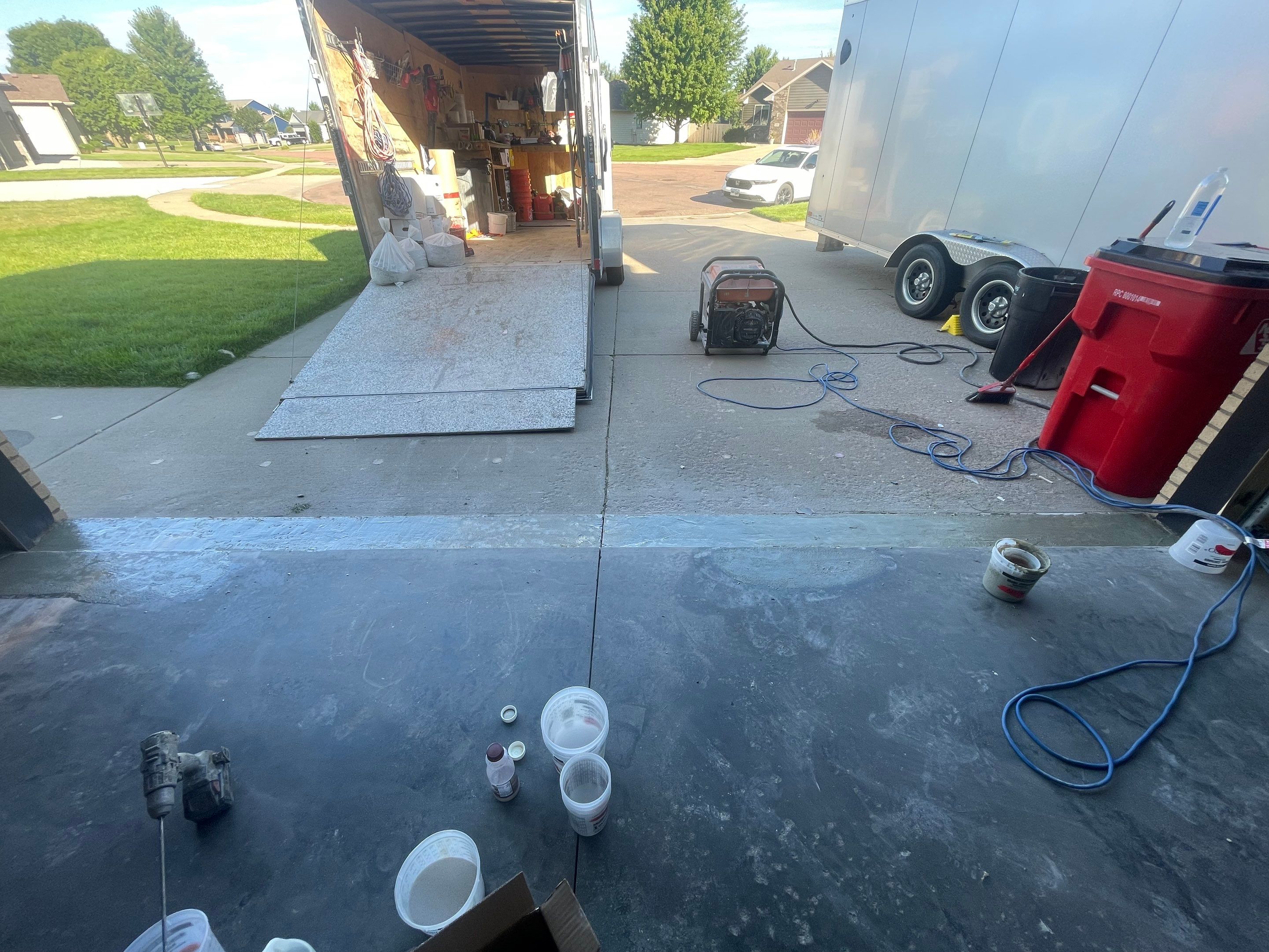 Cabin FEver Flake Garage Floor Coating Installation in Sioux Falls by Select Painting, Coatings & Garage Cabinets