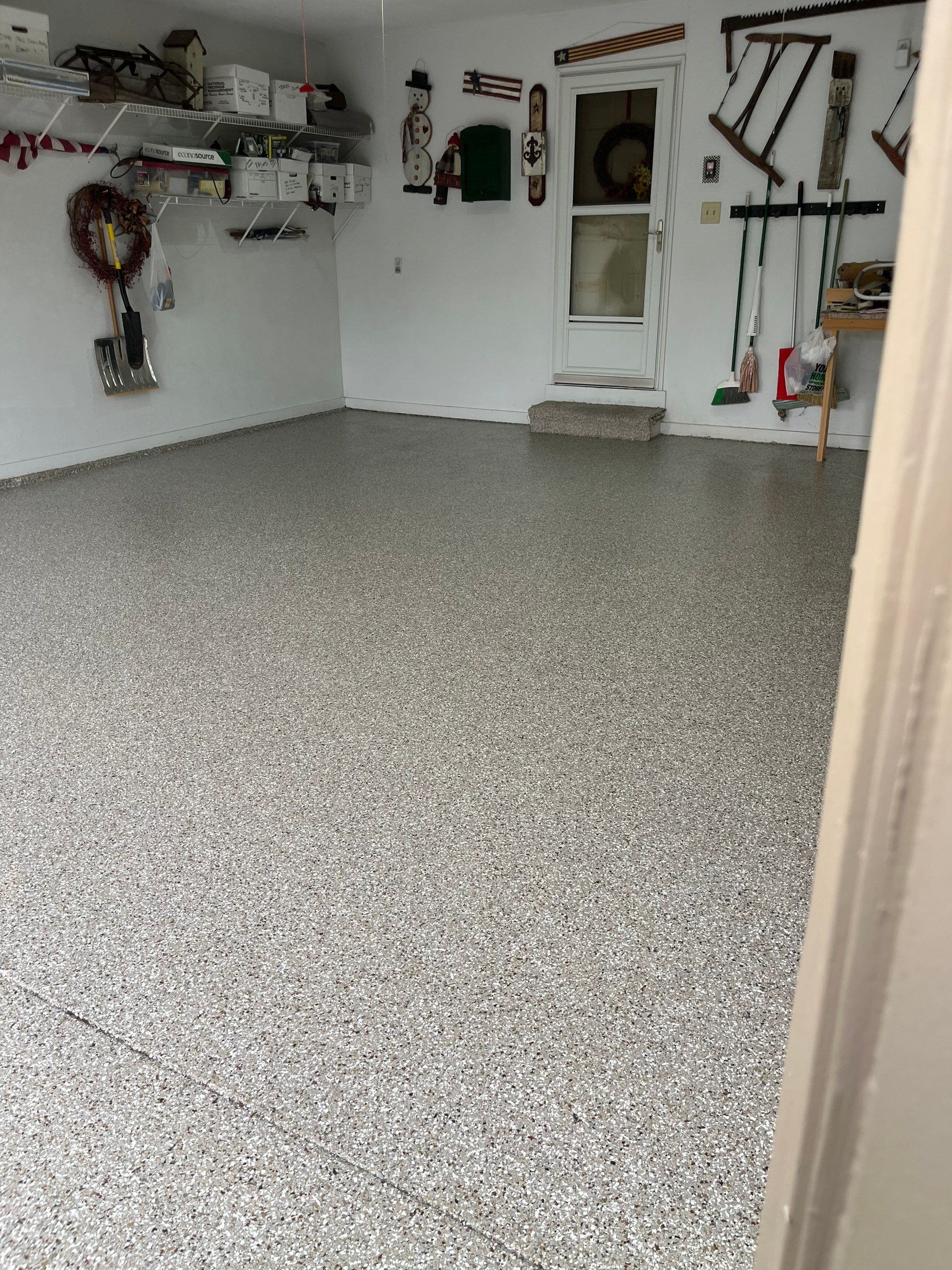 West Des Moines Garage and Patio Floor Coating using Pebble Beach Flakes by Revival Concrete Coatings