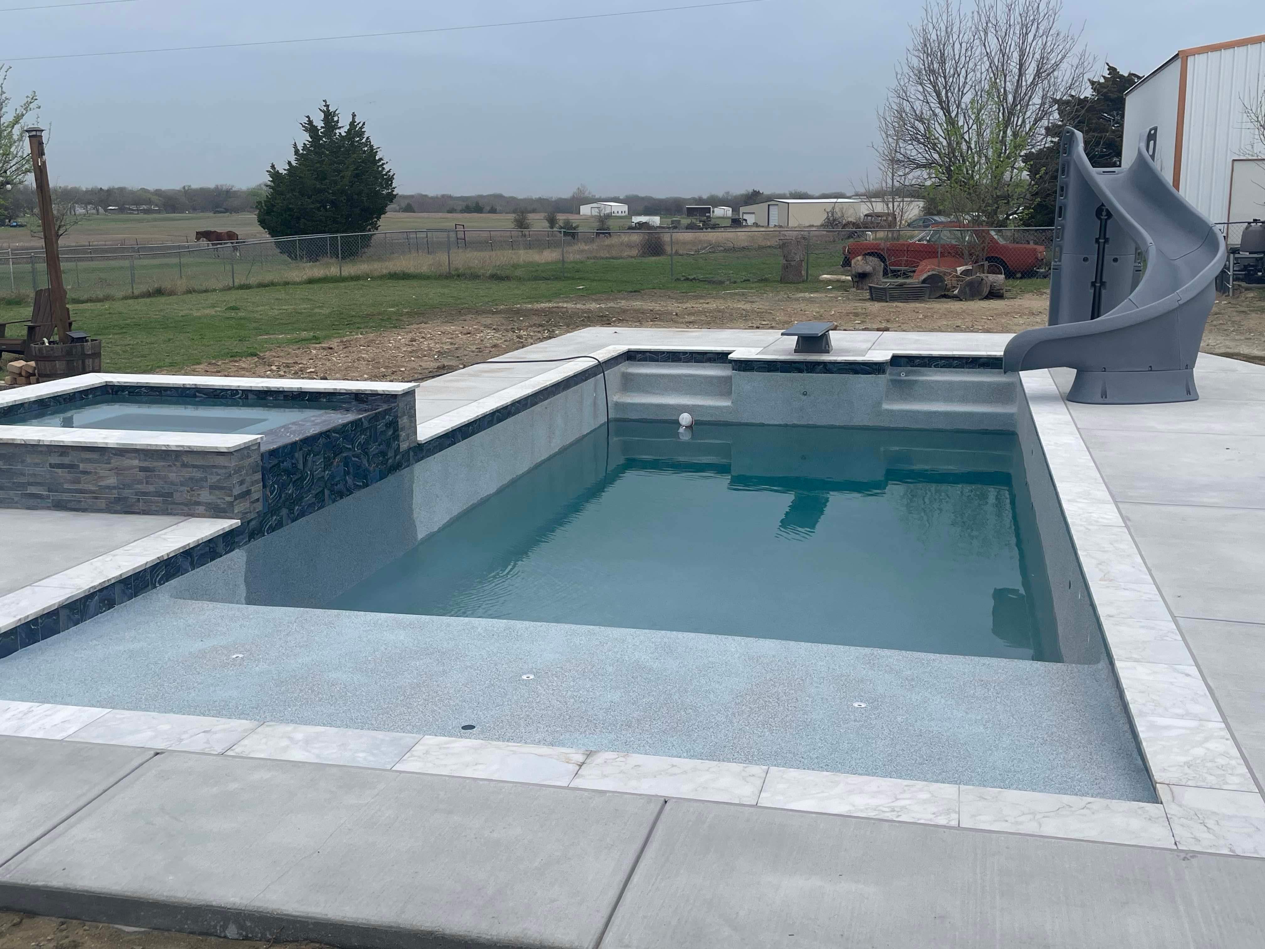 Geometric Pool with Beach Entry, Slide and Raised Spa by Pinnacle Pools and Spas - DFW