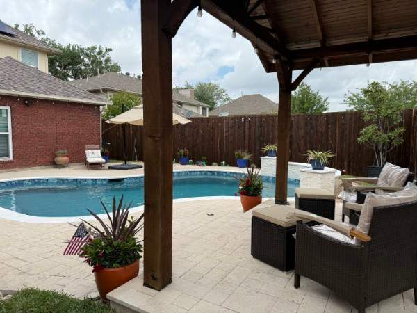 Resort-Style Freeform Pool with Travertine Decking by Pinnacle Pools and Spas - DFW