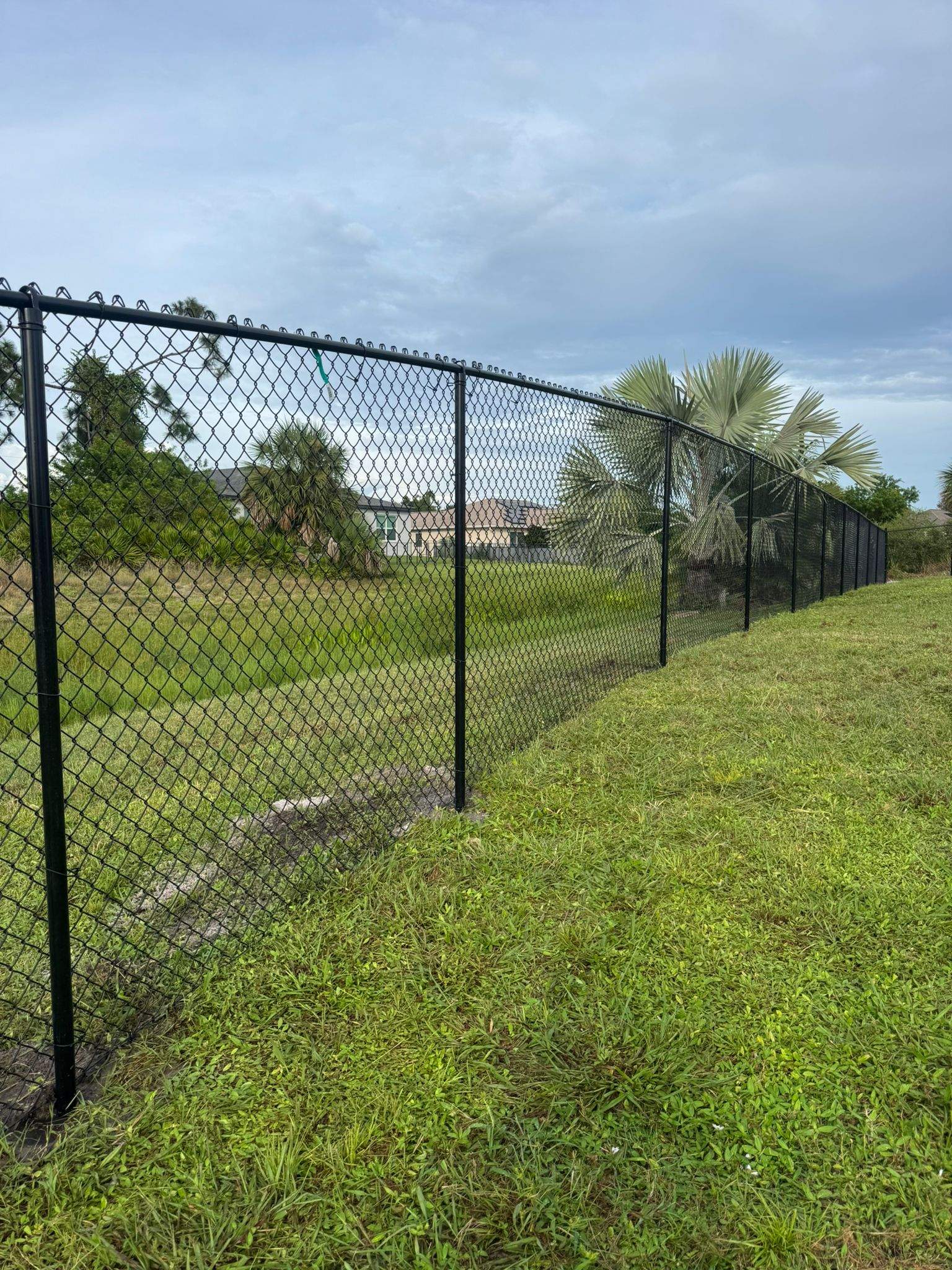 Black Vinyl-Coated Chain Link Fence and Gate Installation in North Port by True Fence LLC