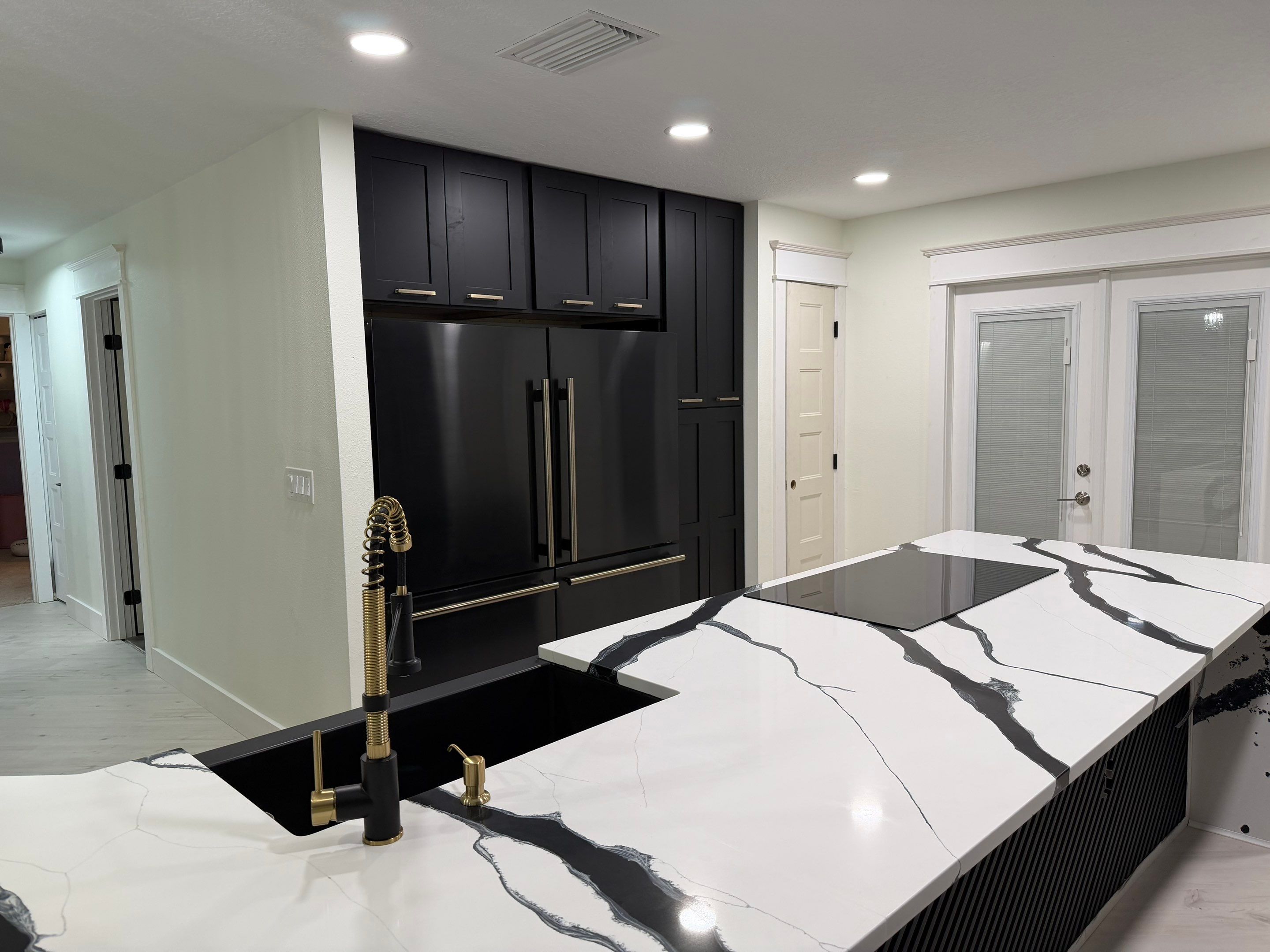 Modern Kitchen Remodel in Port Orange Featuring Waterfall Quartz Island by Acies Renovations