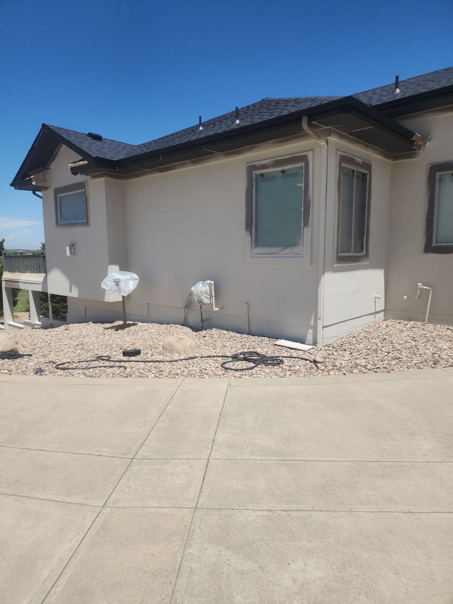 Castle Rock Elegance: White Stucco Exterior with Bold Tricorn Black by J&M Painting LLC