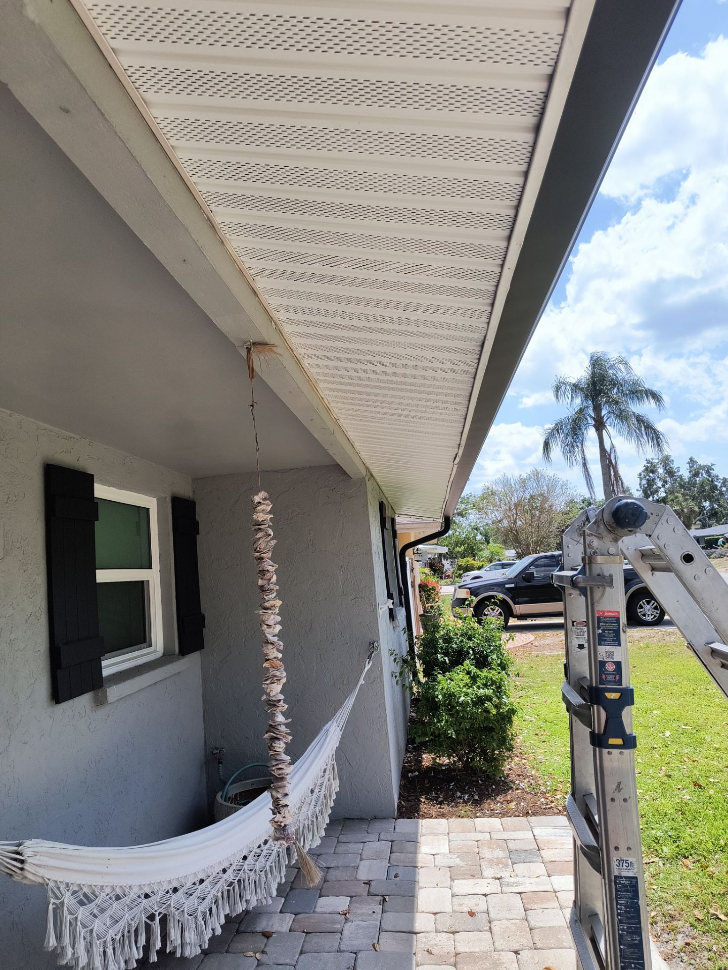 Black Seamless Gutters using 7 inch seamless gutters & New White Soffit in Sarasota FL by Gutter Professors