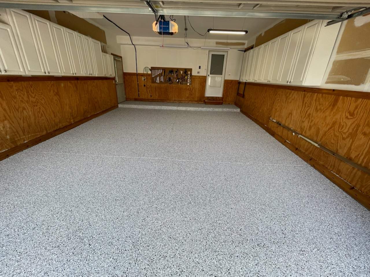 Garage Renovation with Polyaspartic Flooring and Custom Painting in Troy by Top Shelf Painter