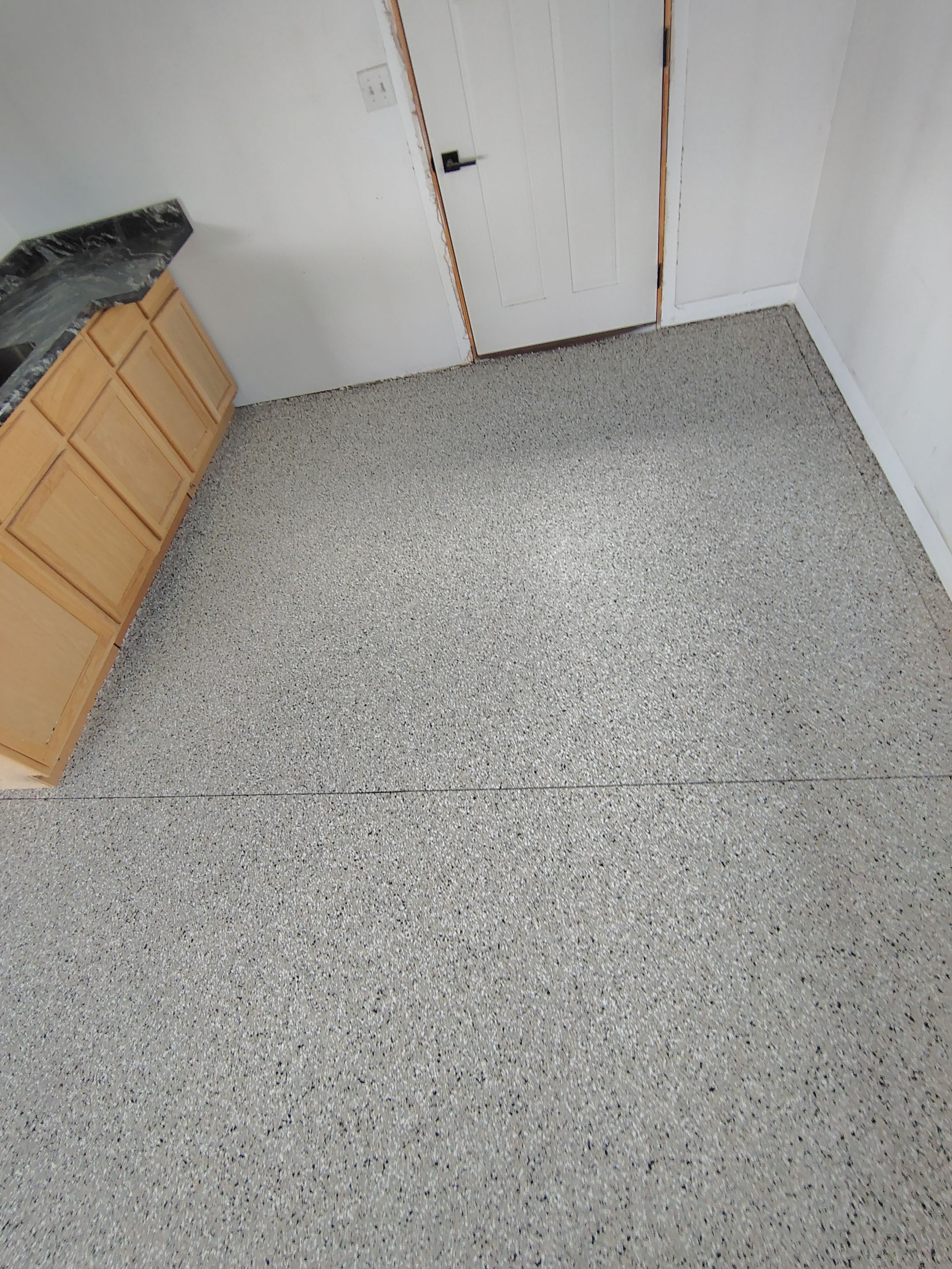 Speckled Polyaspartic Garage Floor Coating Installation in Dell Rapids by Select Painting, Coatings & Garage Cabinets