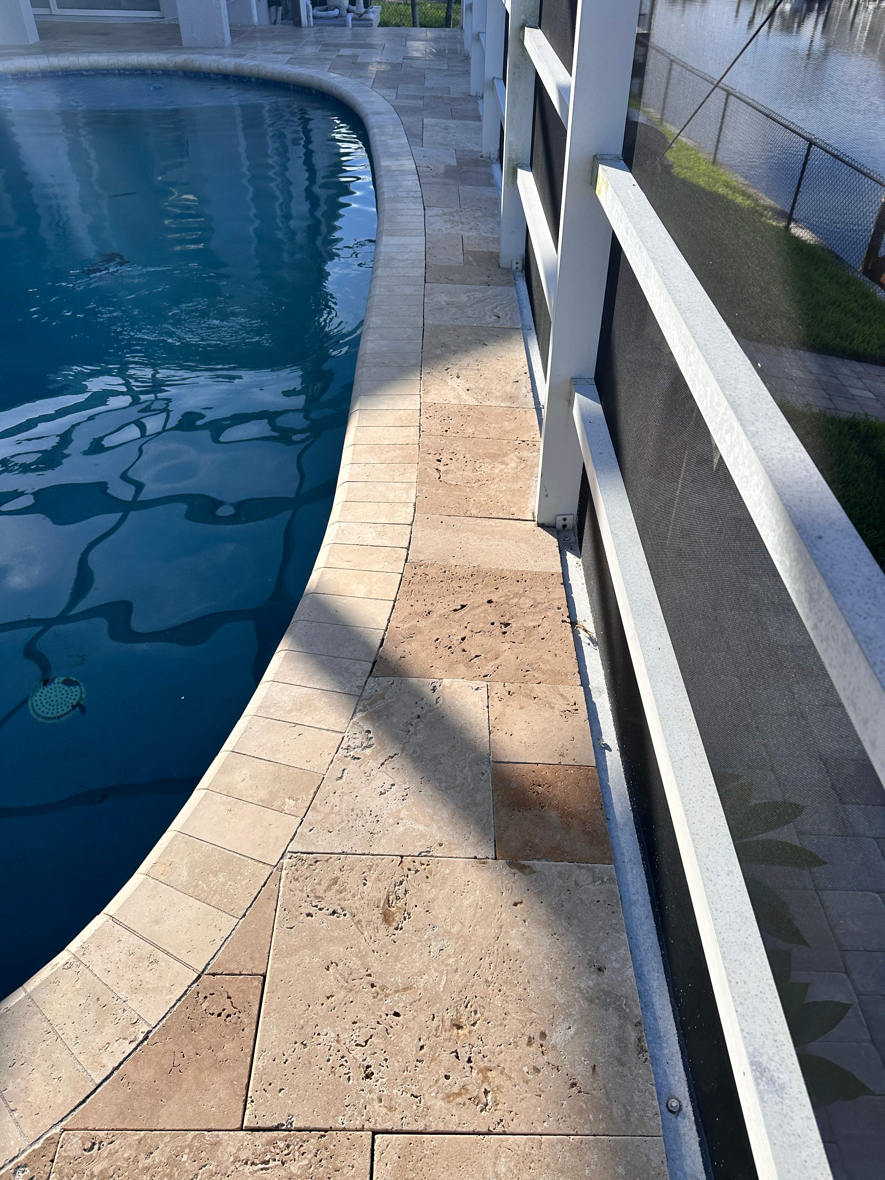 Travertine Sealing and Stripping for a Waterfront Pool Deck in Apollo Beach by Supreme Paver Experts