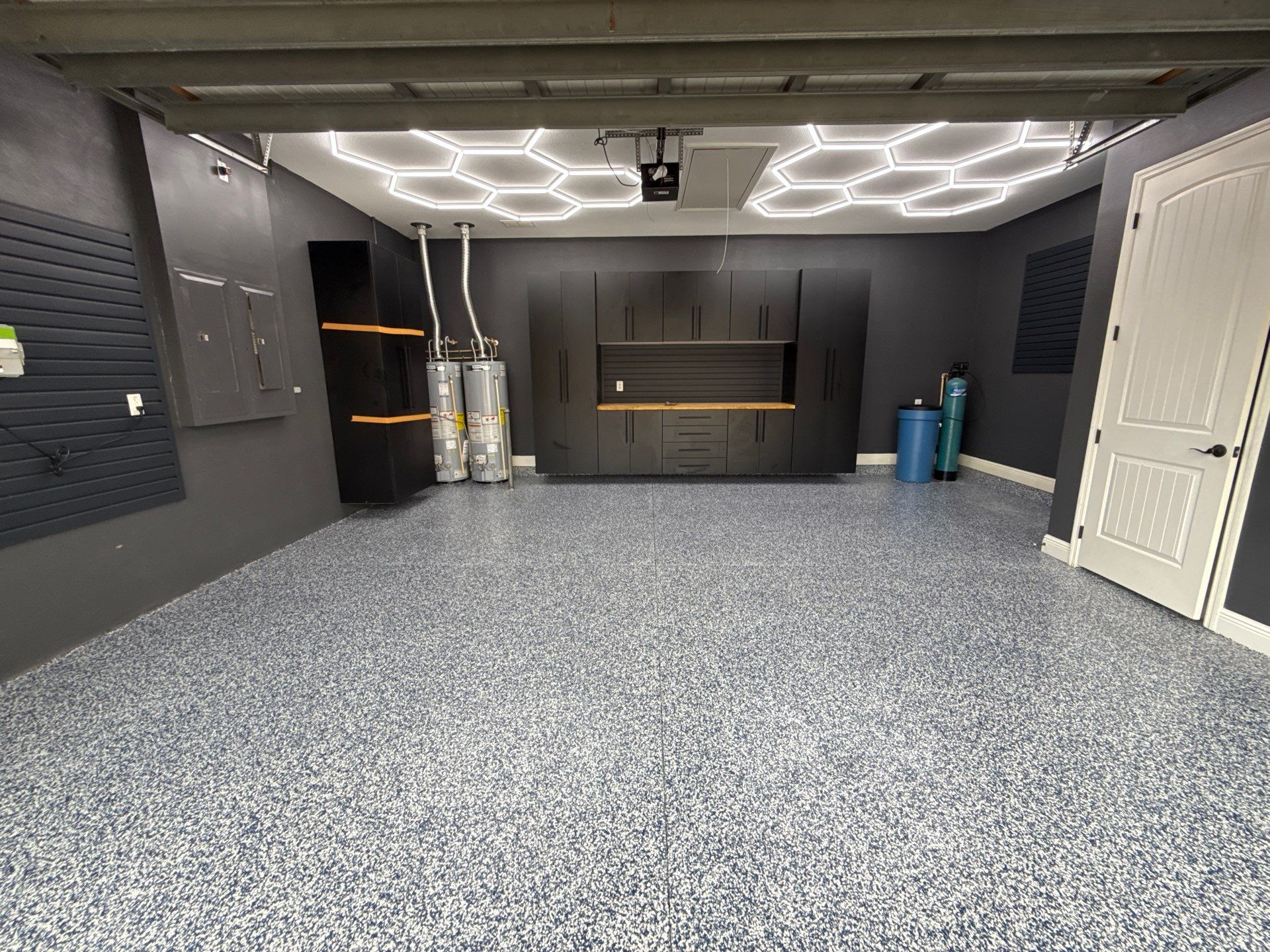 Custom Garage Makeover in Lutz Featuring Hex Lighting and Epoxy Floors by Square 1 Garage and Closet Solutions