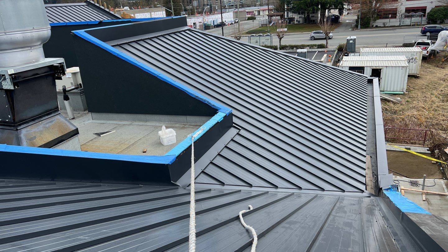 Commercial Roofing Installation using 12" Prolok metal and hidden gutters! by Top Notch Roofing Inc
