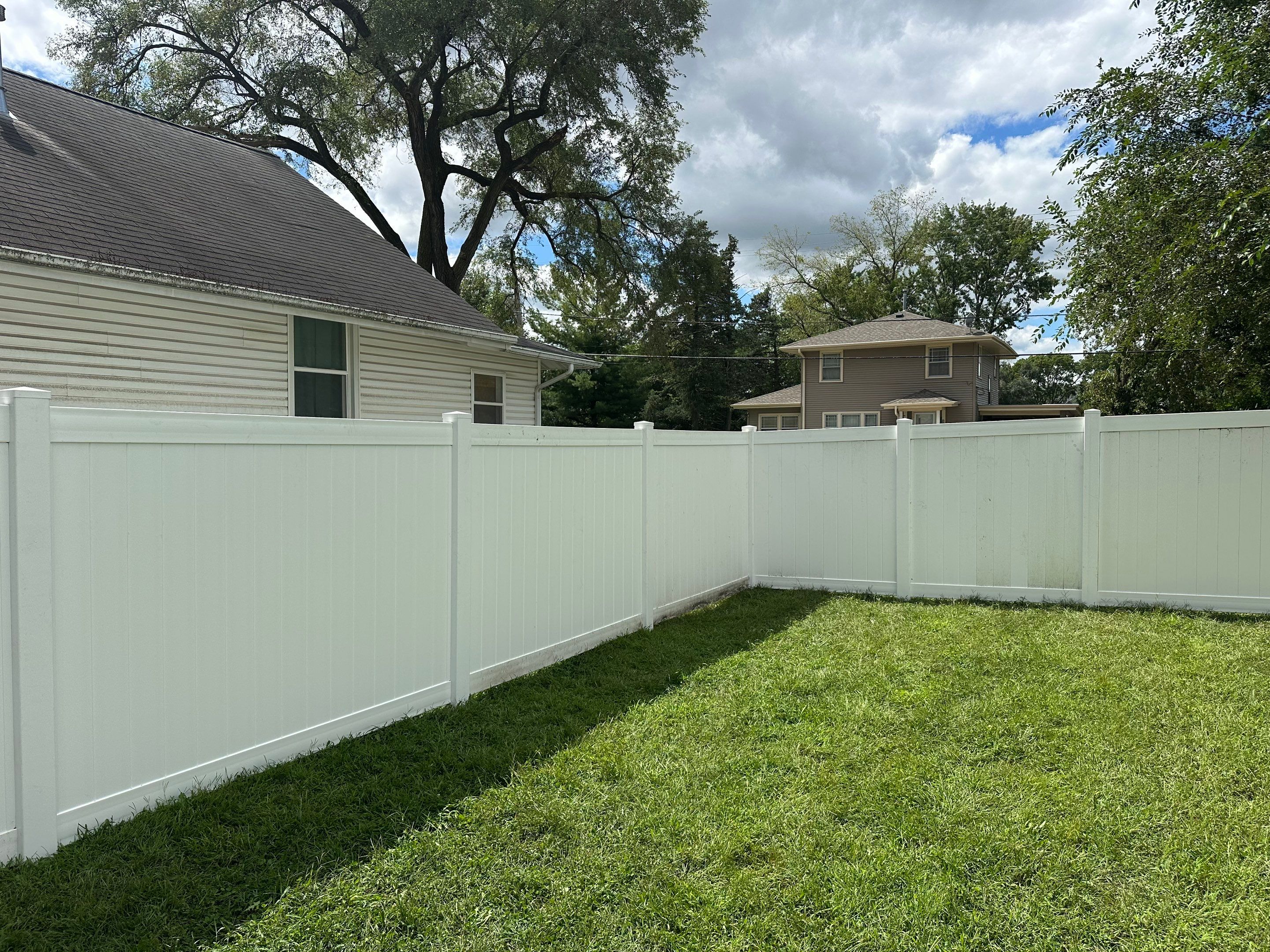Residential White Vinyl Privacy Fence Installation in Waterloo, Iowa by Perfect Picket Fence and Stain