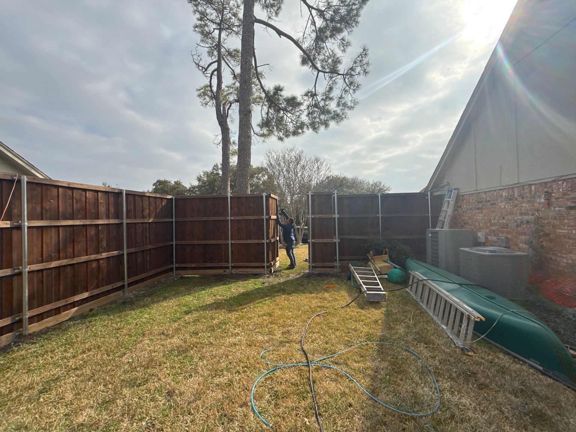 Pre-Stained board on board w/ trim and kickboard using 1x4 cedar trim by Grizzly Fence And Patio