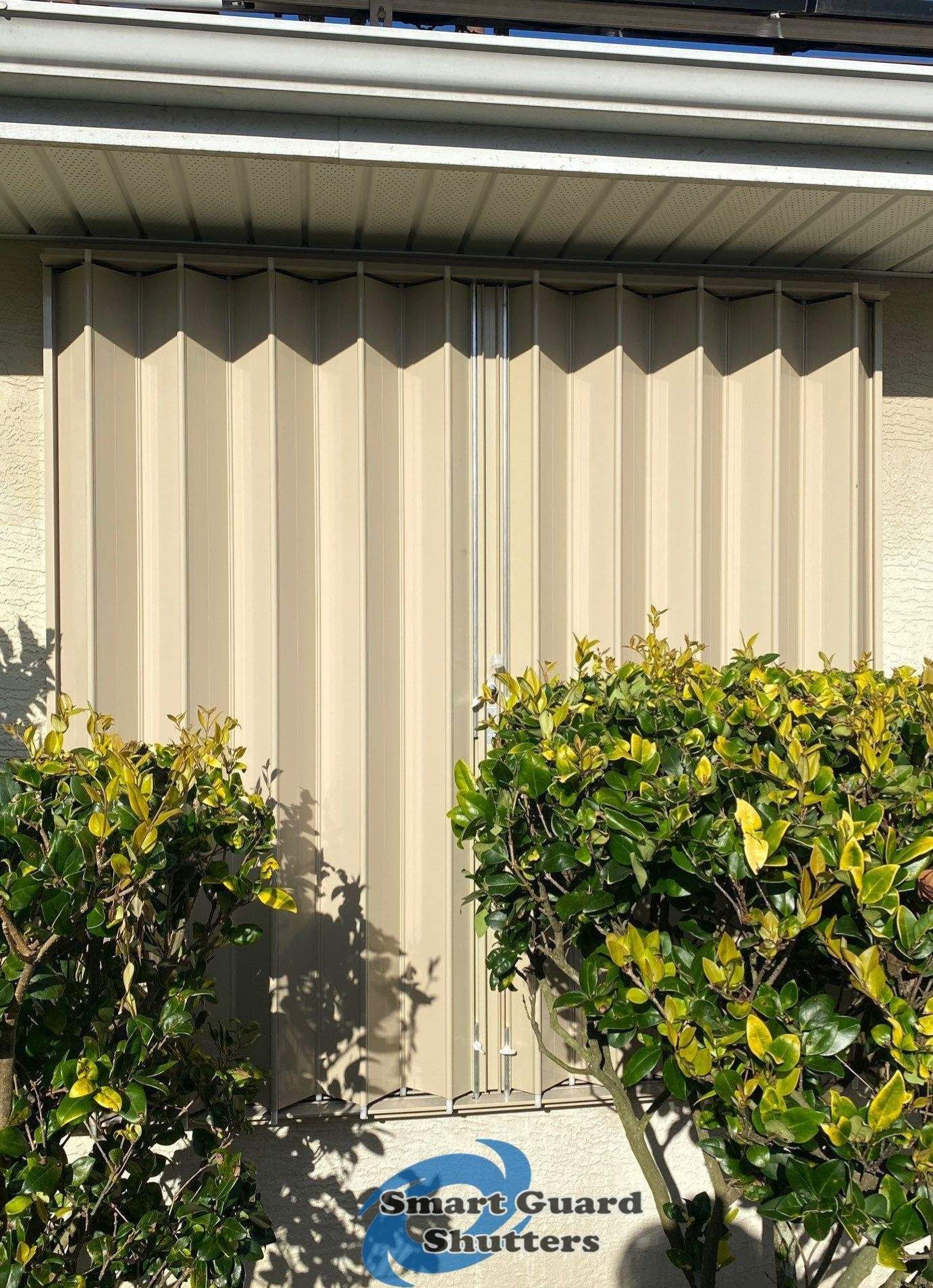 Accordion Shutters in Beige by Smart Guard Shutters