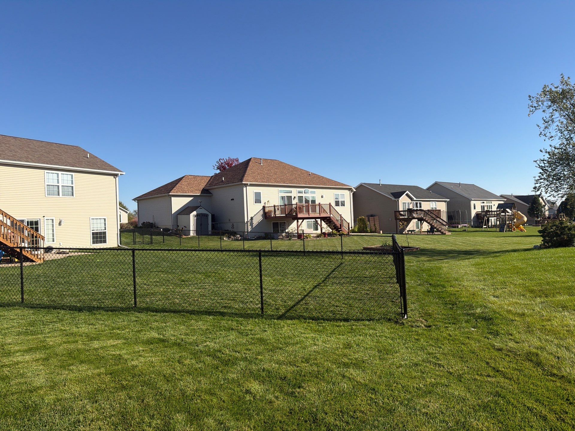 Black Vinyl-Coated Chain Link Fence Installation in Cedar Falls by Perfect Picket Fence and Stain