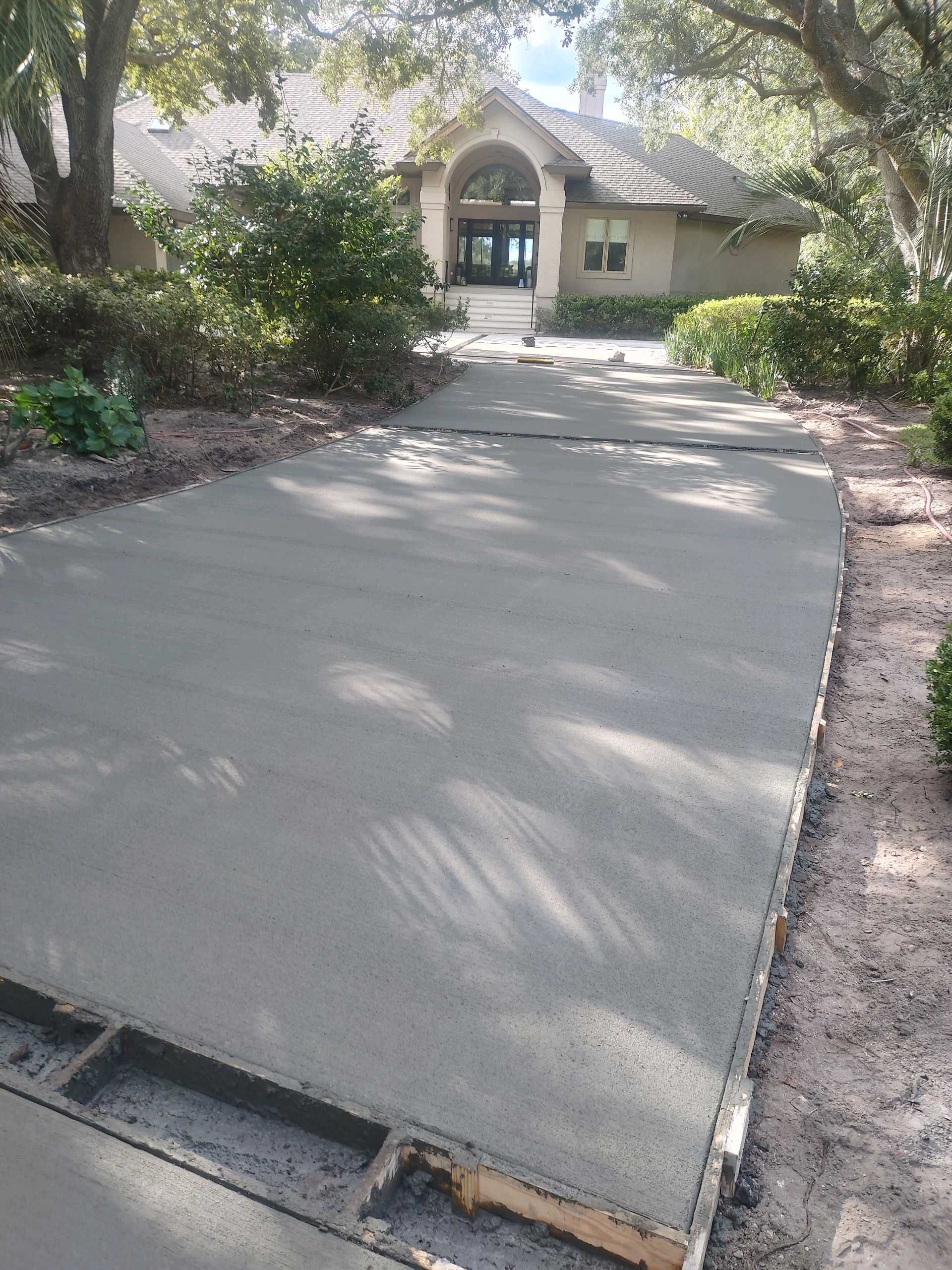 Custom Concrete Driveway with Decorative Paver Inlays in Hilton Head Island by Lowcountry Scapes, LLC