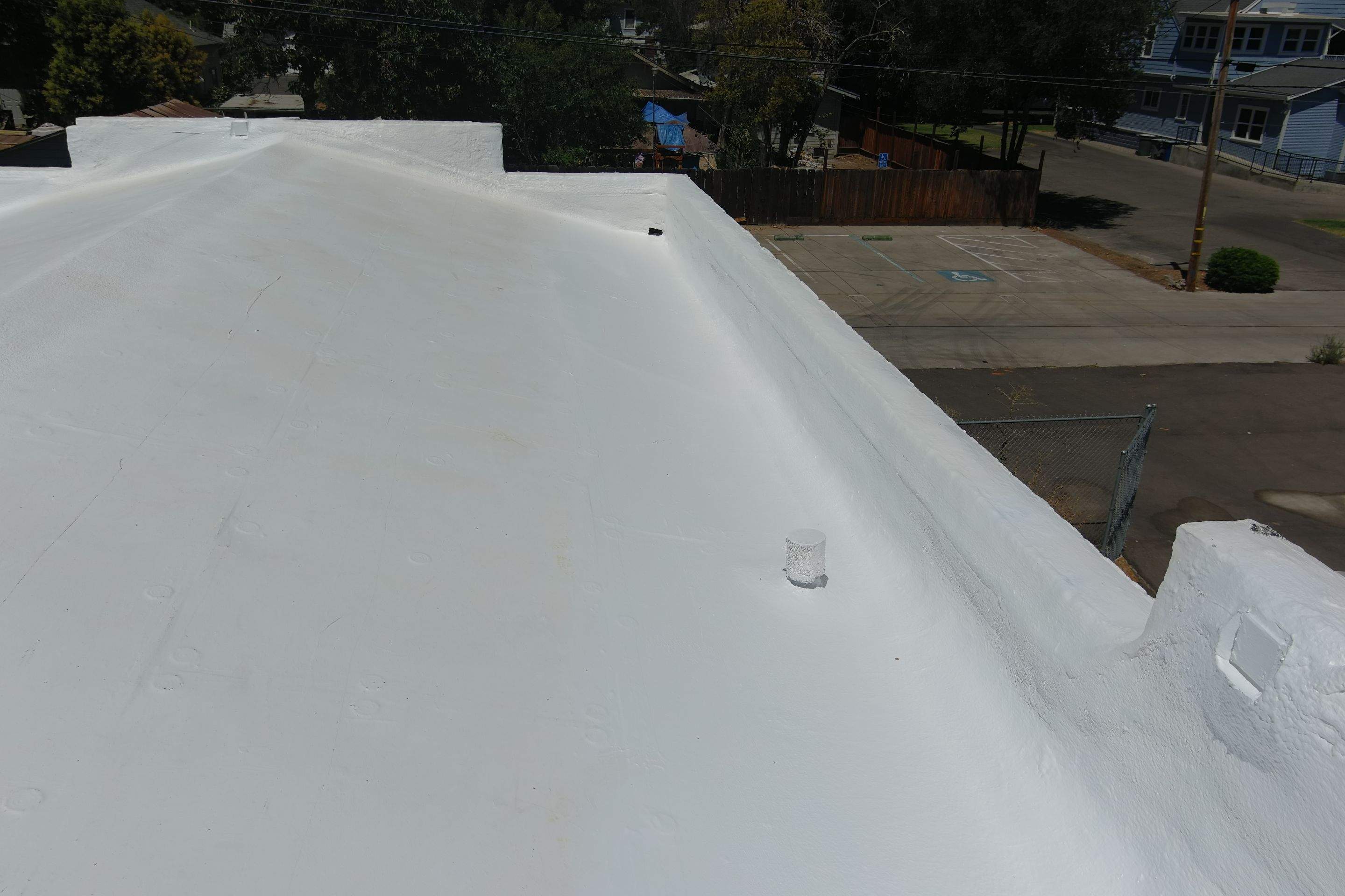 Commercial Roofing Installation using Conklin BenchPly system with PUMA top coat (imbedded fabric system) by Straight Edge Roofing Inc