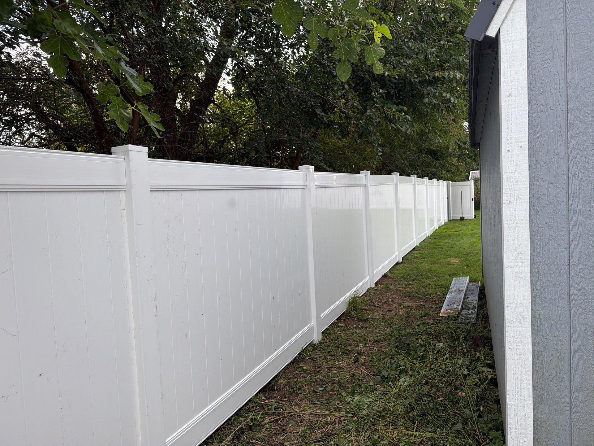 White Vinyl Privacy Fence Installation in Raymond, IA by Perfect Picket Fence and Stain