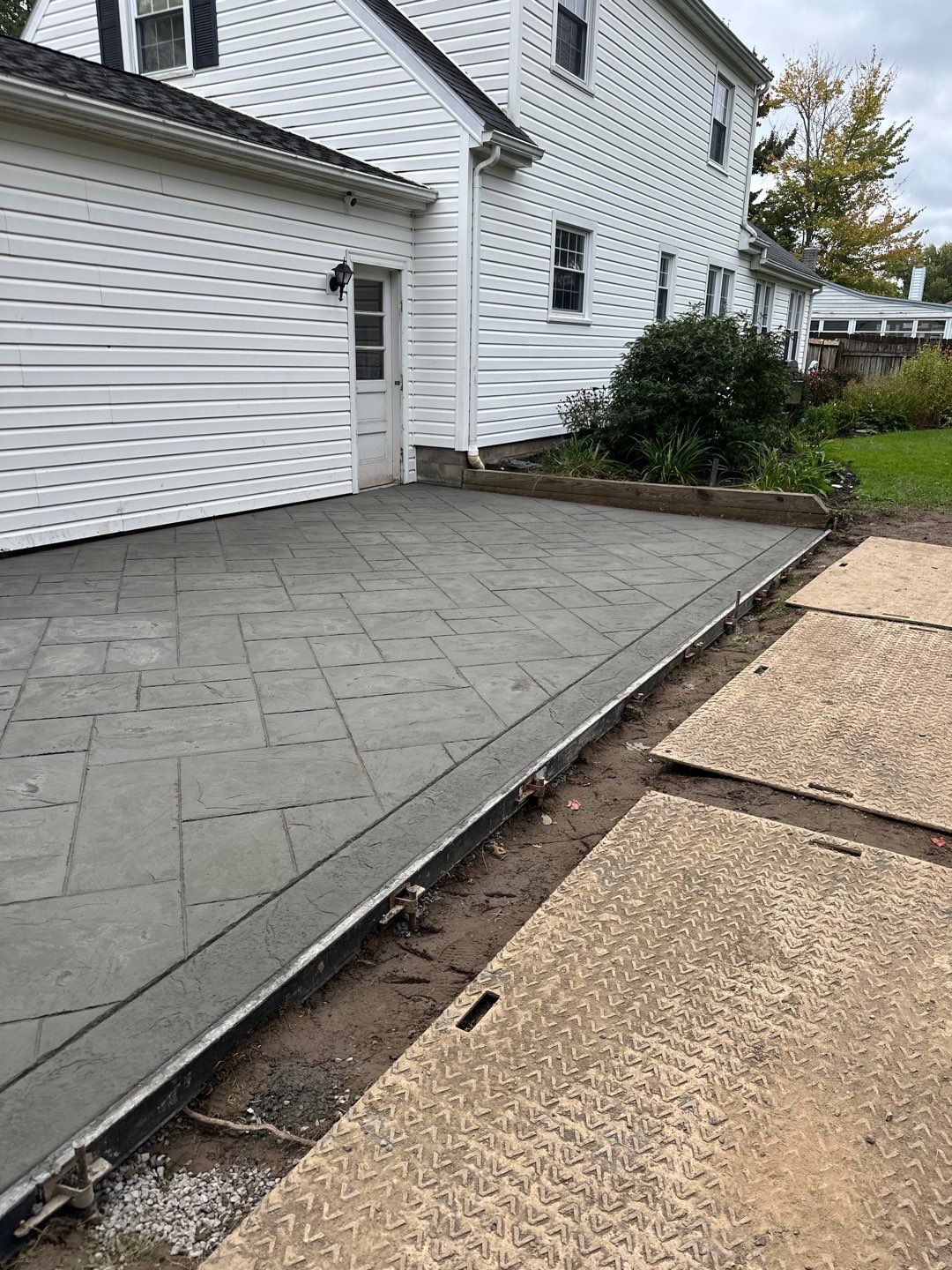 Majestic Ashlar stamped concrete patio with a border  by NG Masonry & Construction LLC