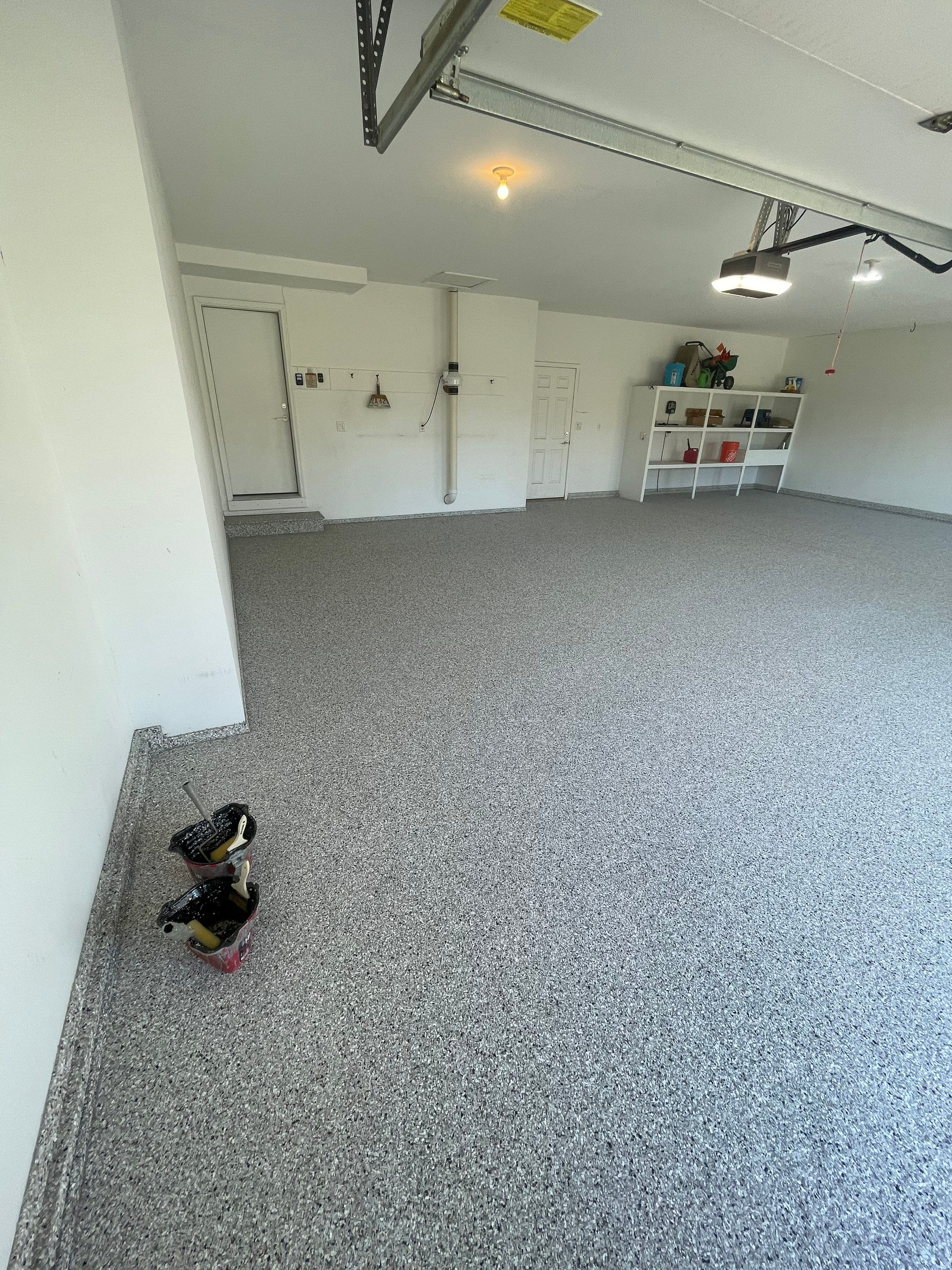 Yankton Garage Floor Restoration with Gray Speckled Epoxy Coating by Select Painting, Coatings & Garage Cabinets