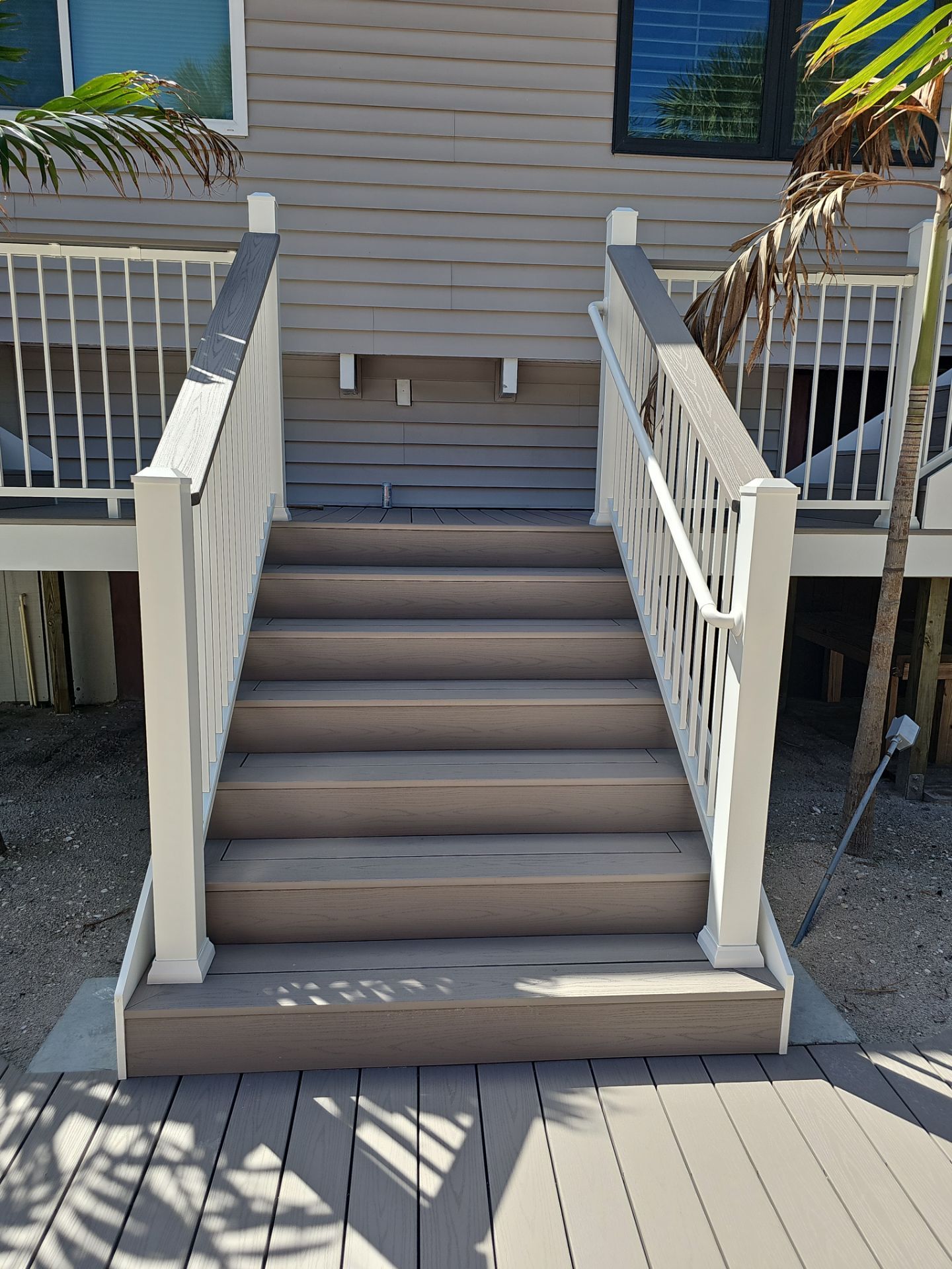 Elevated Home Deck Reconstruction With White Aluminum Railings in Placida by Smirnov Construction Inc