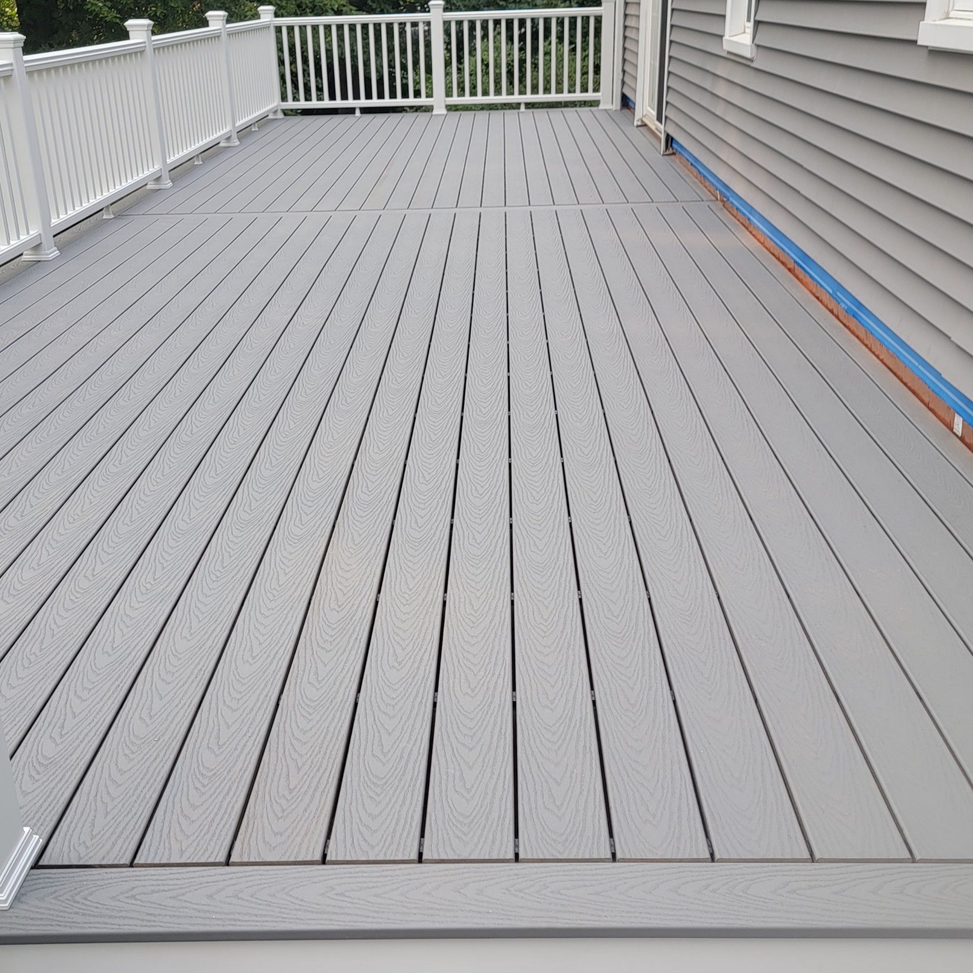 Deck replacement using Trex Select Pebble Gray and transcend White railing. by DiGiorgi Roofing and Siding Inc