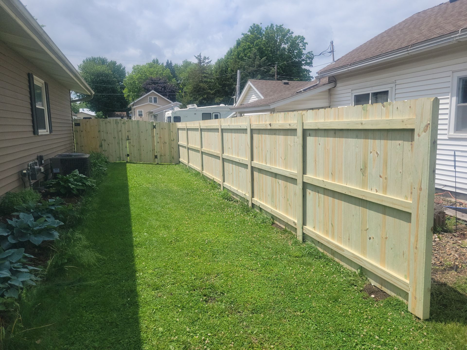 Pressure-Treated Wood Privacy Fence Installation in Charles City by Perfect Picket Fence and Stain