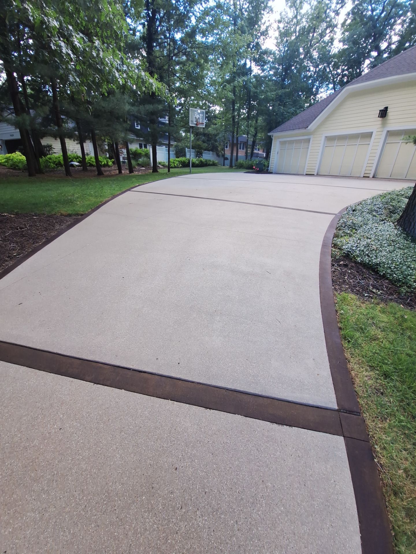 Concrete Driveway and Walkway Staining With Espresso Borders in Grand Rapids by Gordon Painting