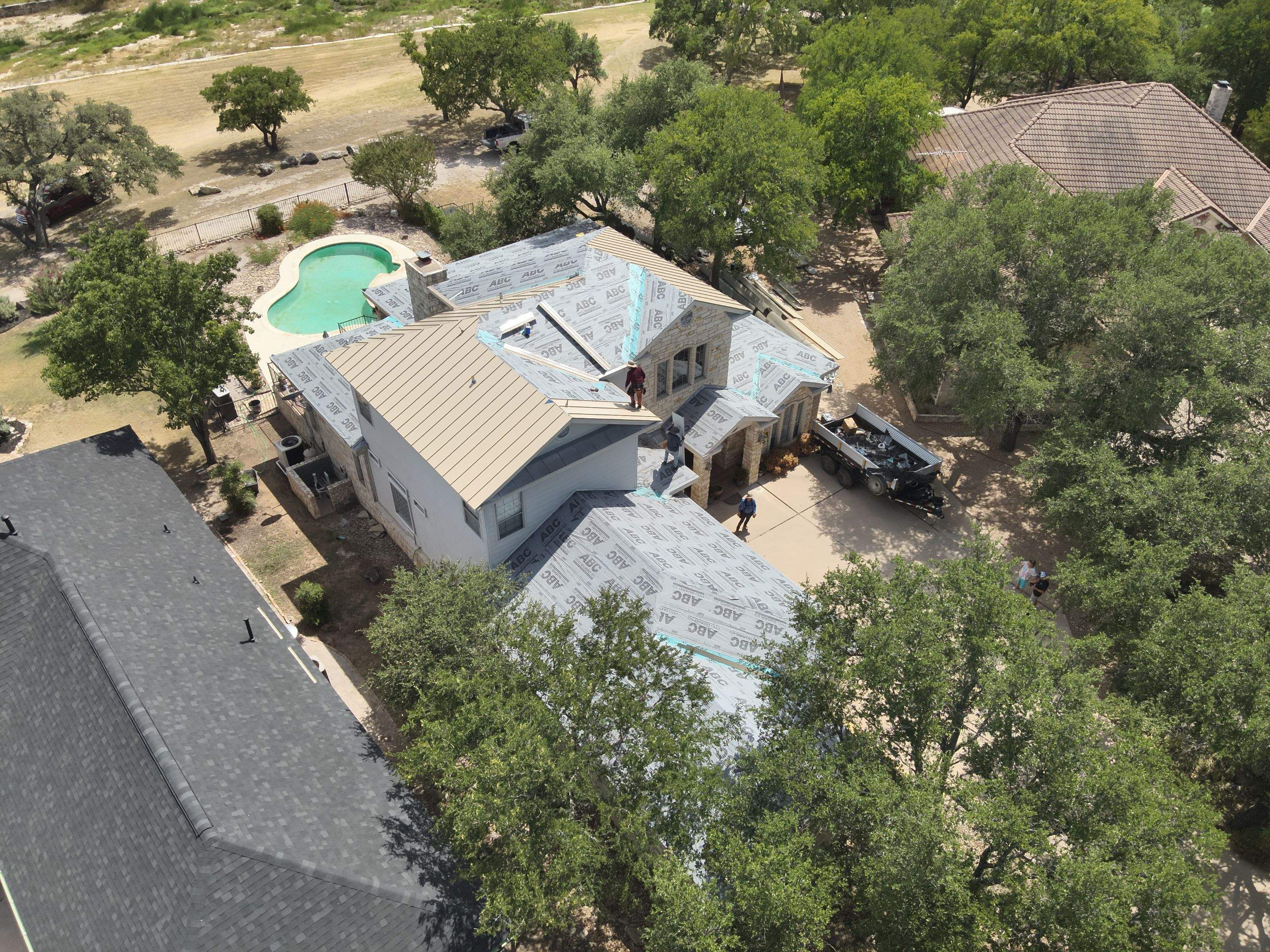 Residential Roof Replacement using 24 GA Double-Lock - Surrey Beige by Action Exteriors Austin