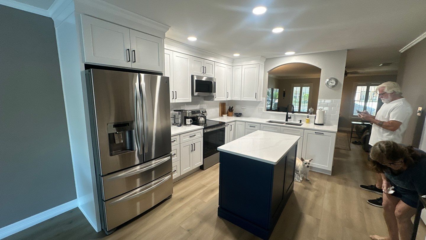 Live Oak Kitchen Refresh Featuring White Shaker Cabinets and Navy Island by Legacy Bath and Kitchen 