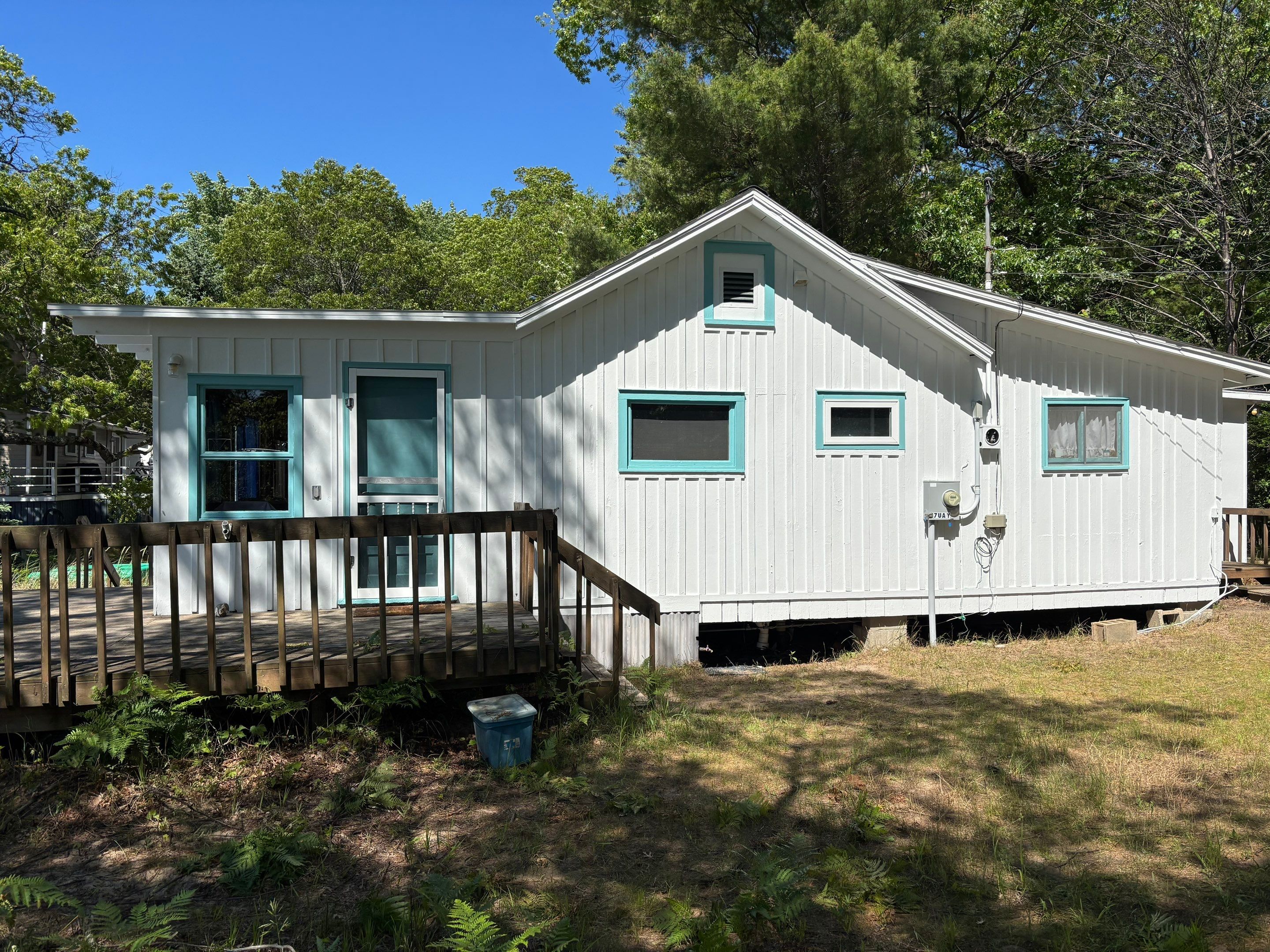 Lakeside Cottage Exterior Painting and Teal Trim Restoration in Mears by Gordon Painting