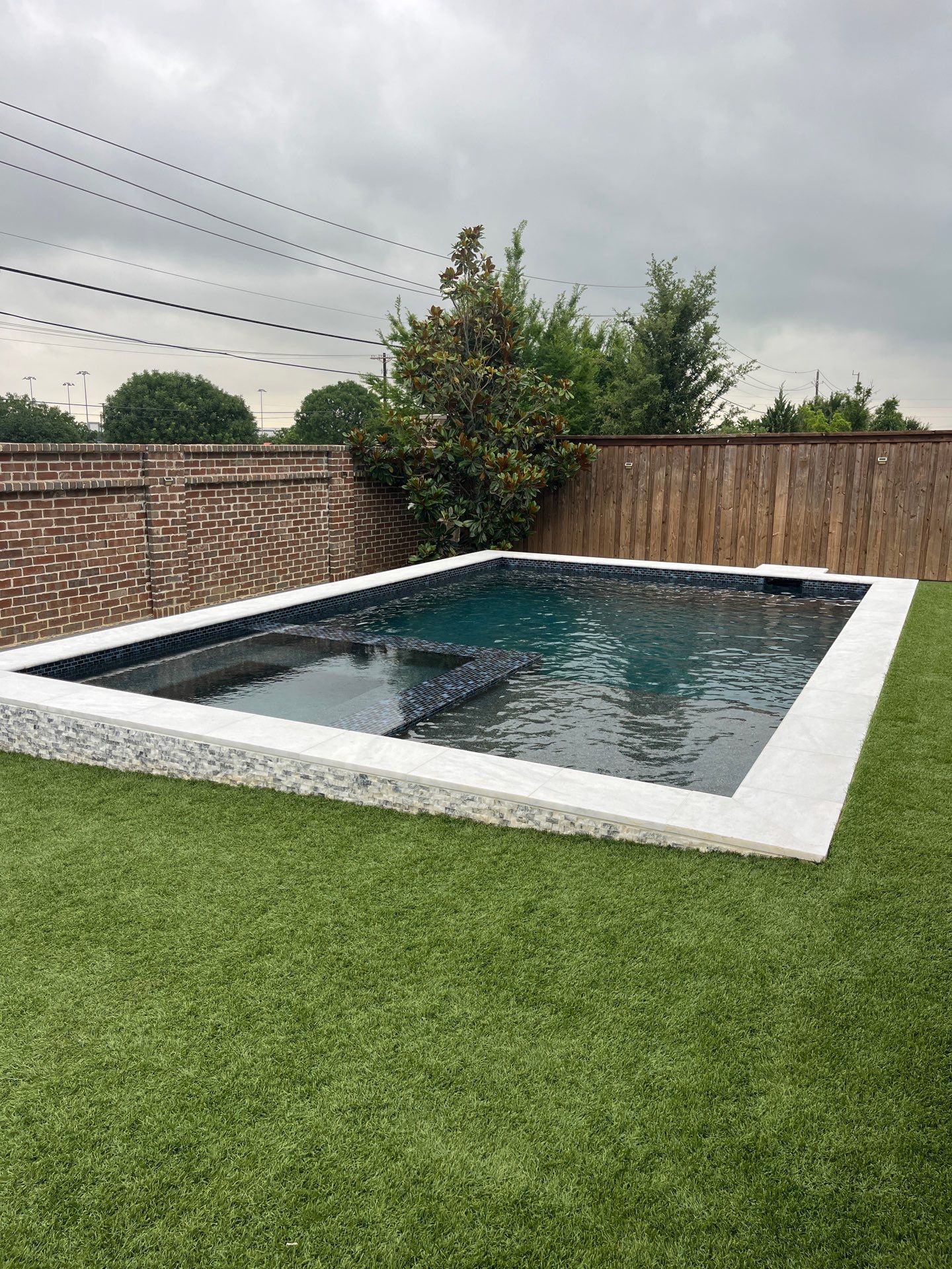 Modern Geometric Pool with Raised Spa and Turf Surround by Pinnacle Pools and Spas - DFW