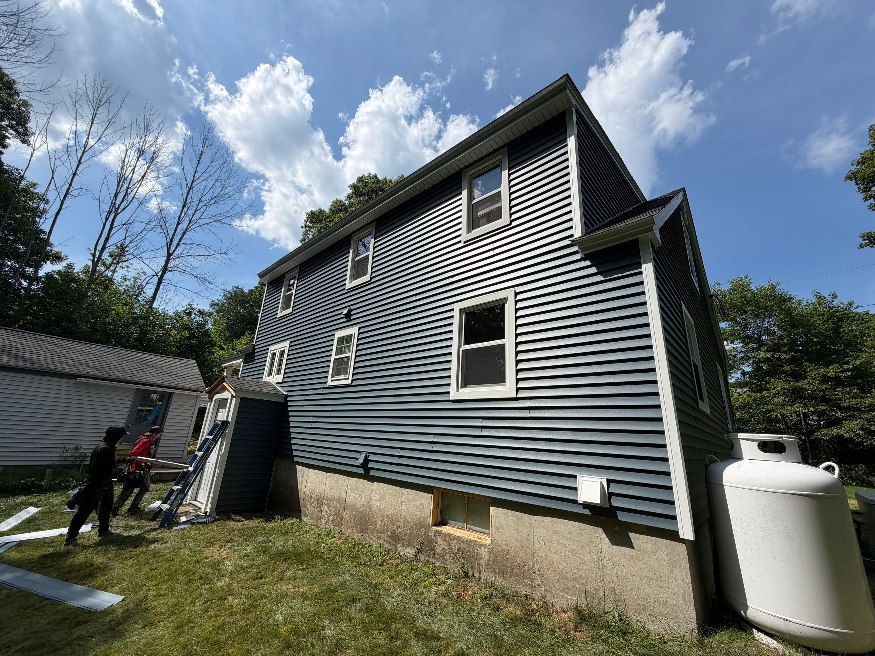 Complete Exterior Renovation Featuring Owens Corning Shingles and Vinyl Siding by Tall pine roofing