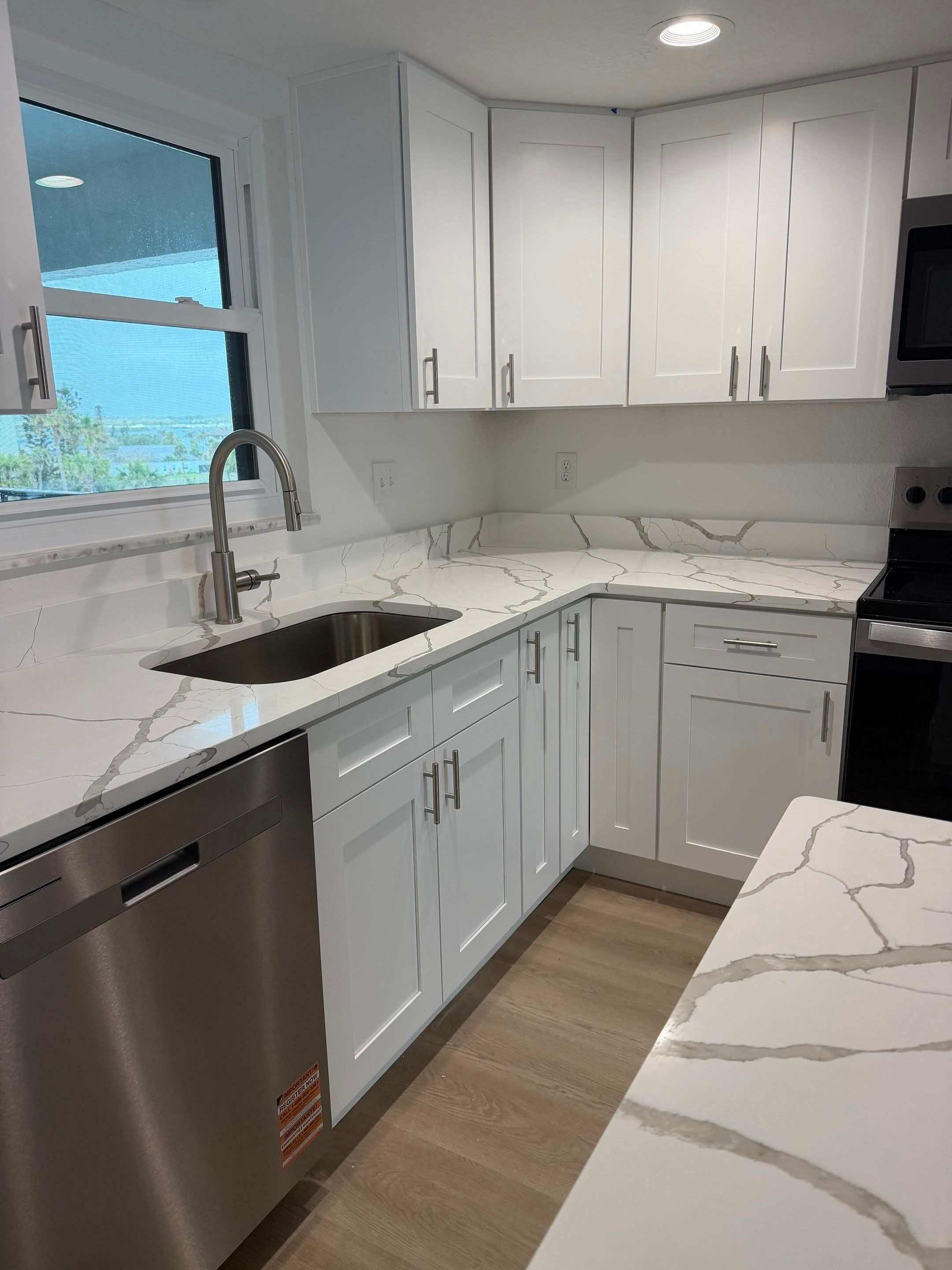 Full Condominium Remodel Featuring Aubrey Oak Flooring In Daytona Beach by Acies Renovations
