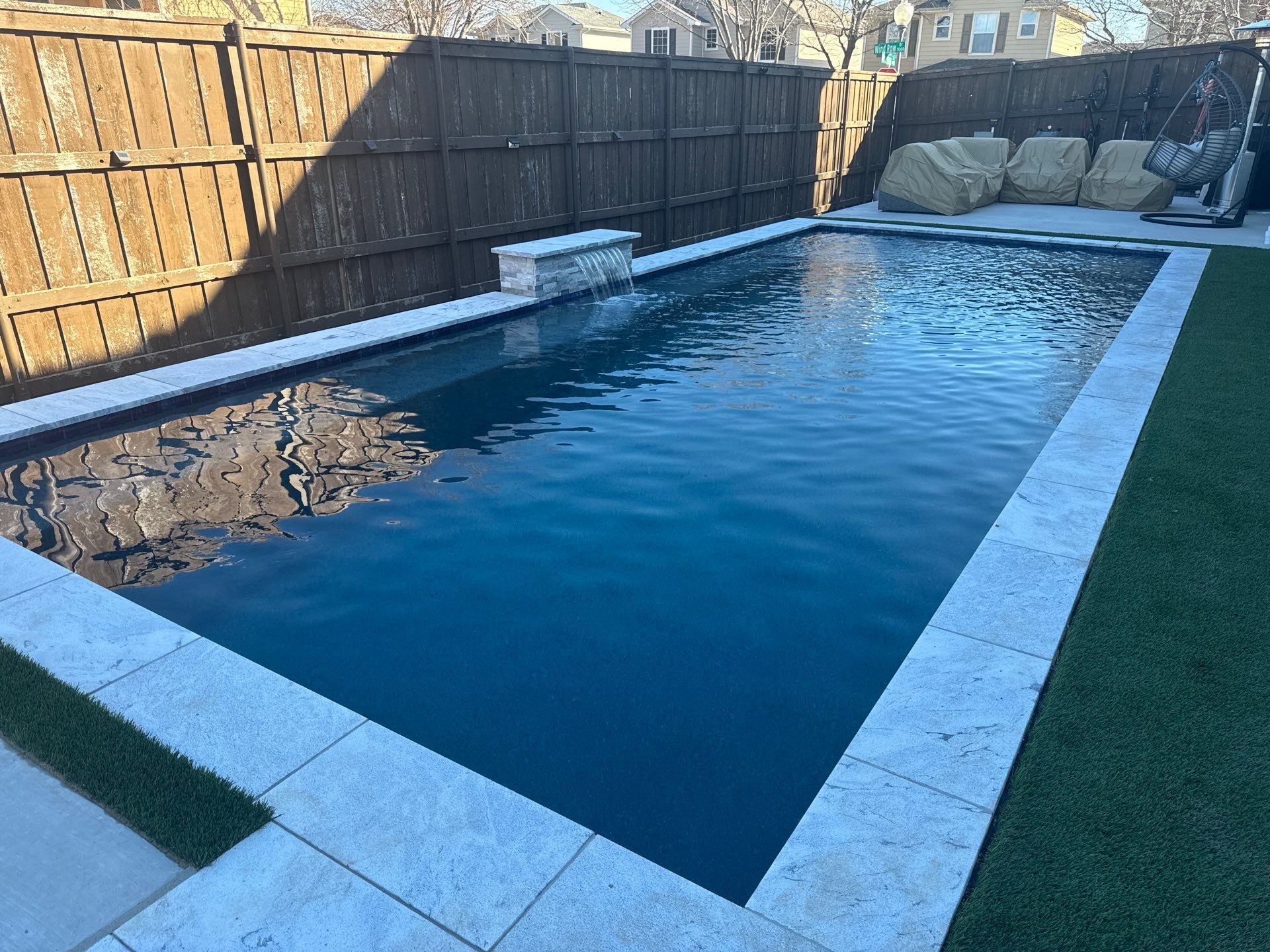 Pool with Turf and Raised Wall by Pinnacle Pools and Spas - DFW