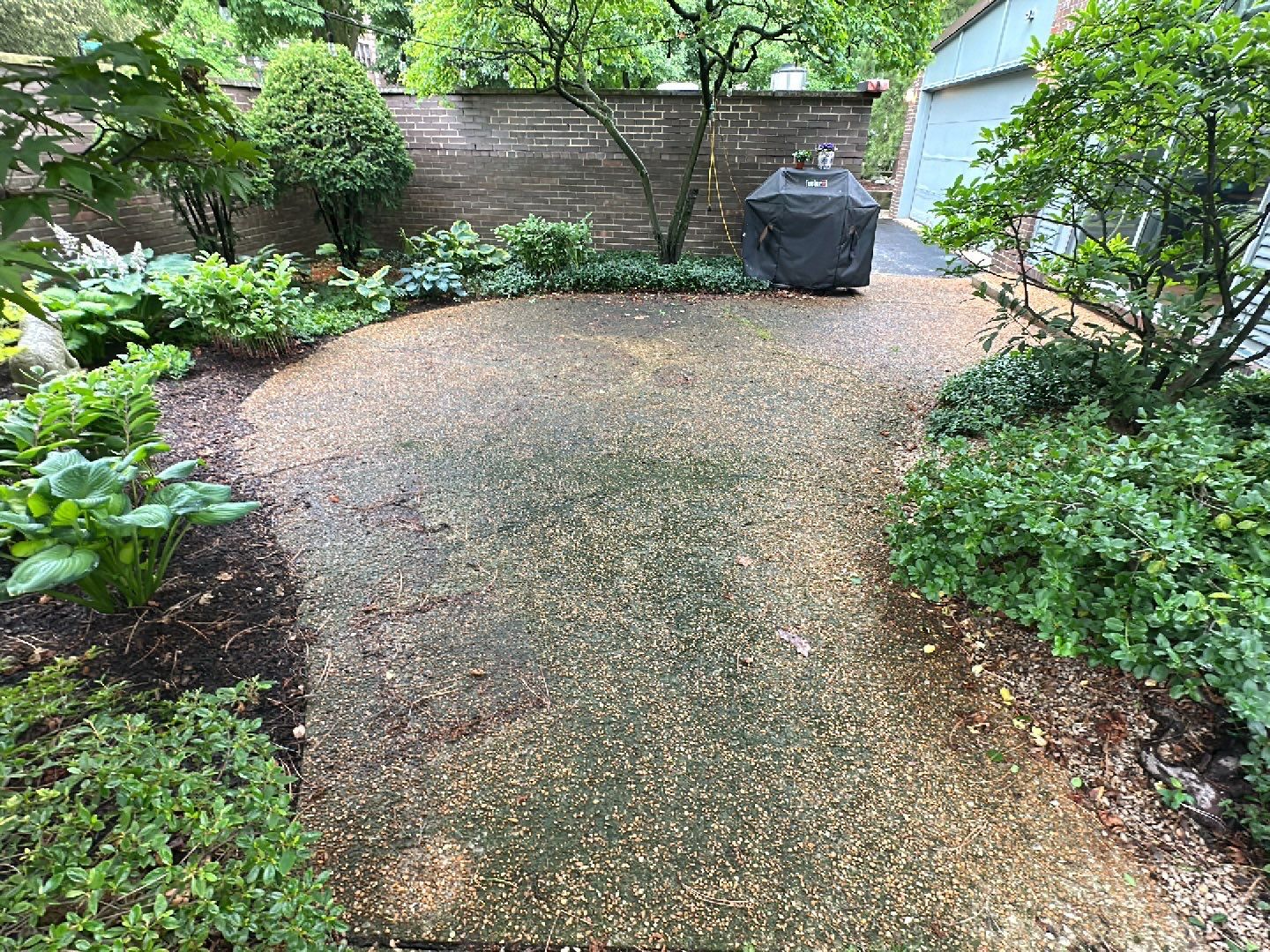 Aggregate and natural stone patio cleaning by Northern Power Washing LLC.