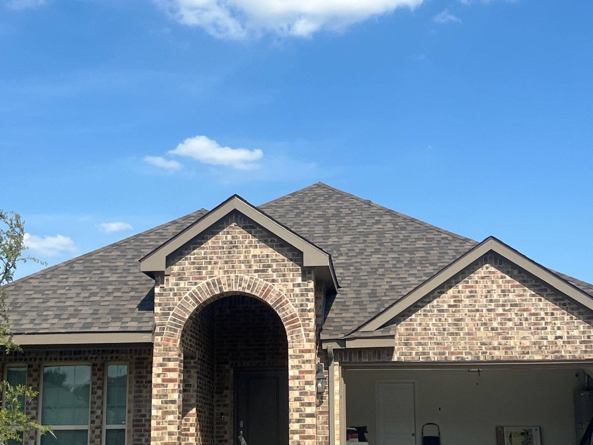 Medium brown brick with IKO Driftshake by Tejas Roofworks + Restoration