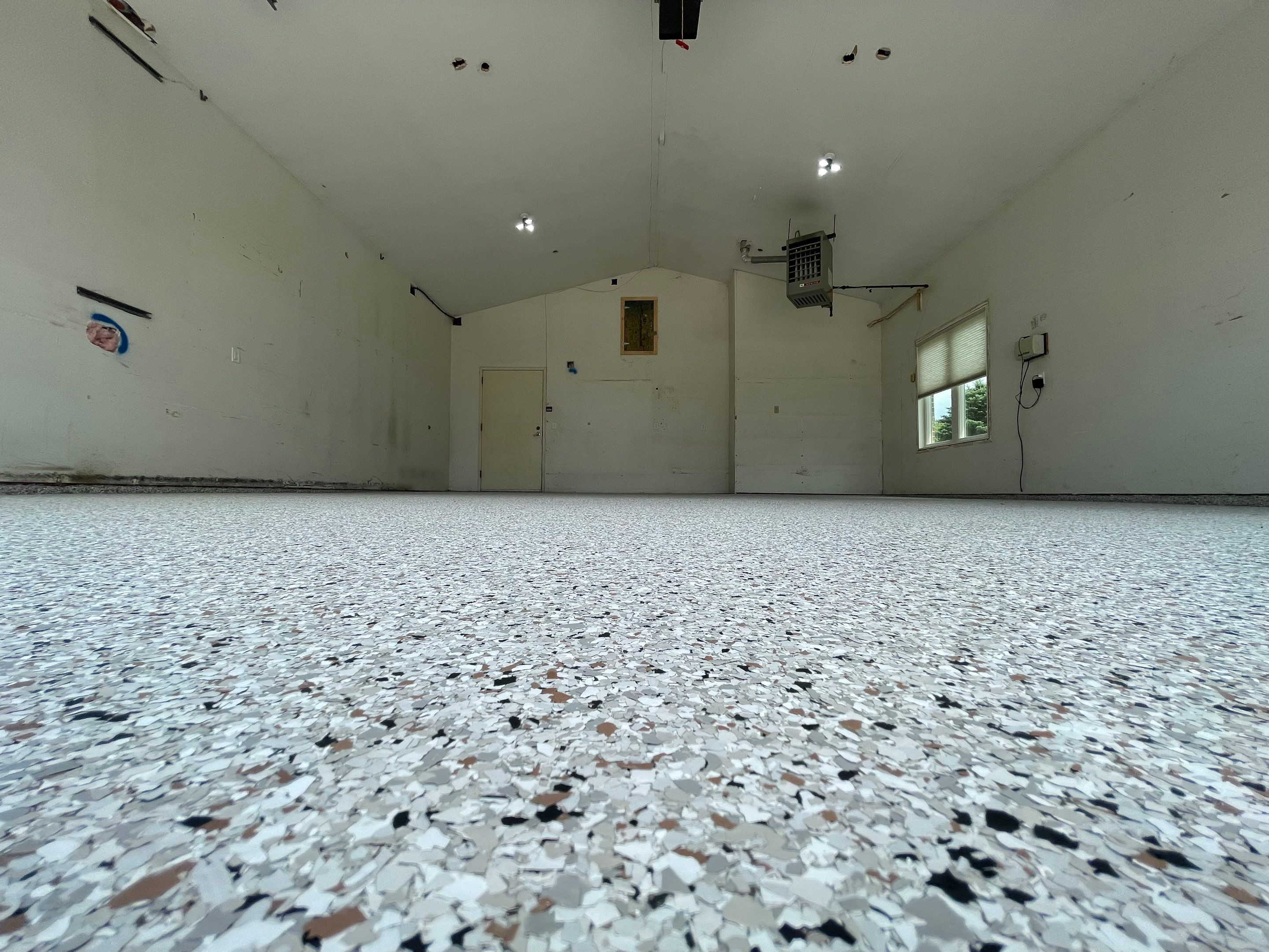 Coyote Flake Concrete Coating for Sioux Falls Garage by Select Painting, Coatings & Garage Cabinets