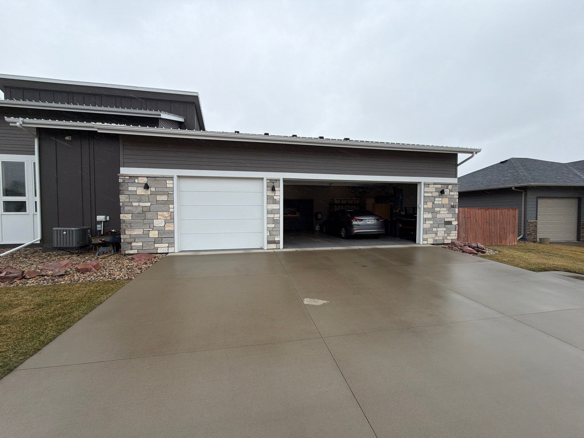 Modern Exterior Transformation Featuring Dark Board and Batten Siding in Sioux Falls by Select Painting, Coatings & Garage Cabinets
