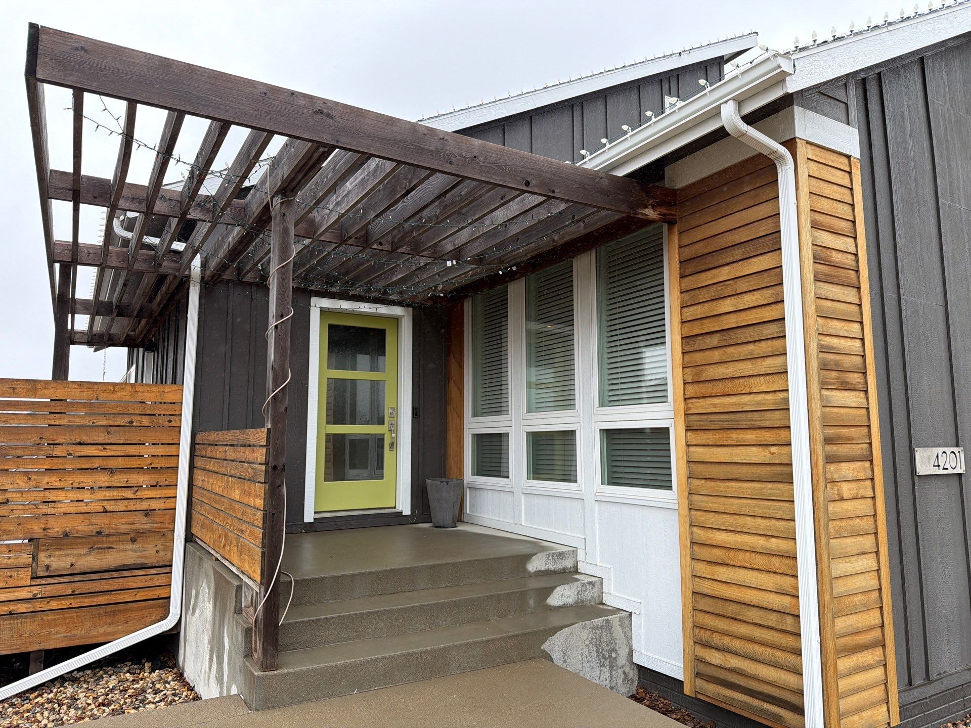 Modern Exterior Transformation Featuring Dark Board and Batten Siding in Sioux Falls by Select Painting, Coatings & Garage Cabinets