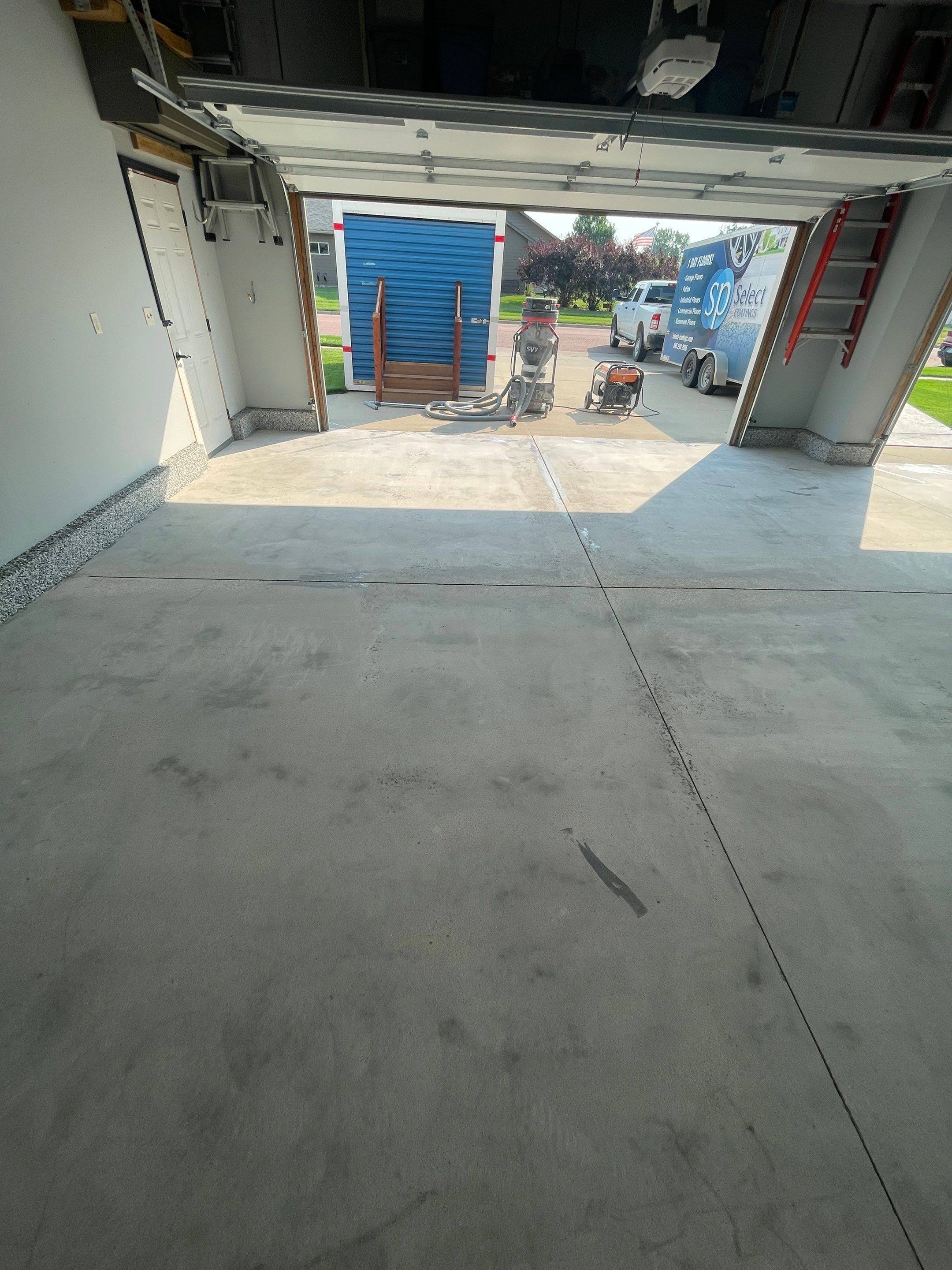 Sioux Falls Garage Concrete Coating Installation with Domino Flake by Select Painting, Coatings & Garage Cabinets