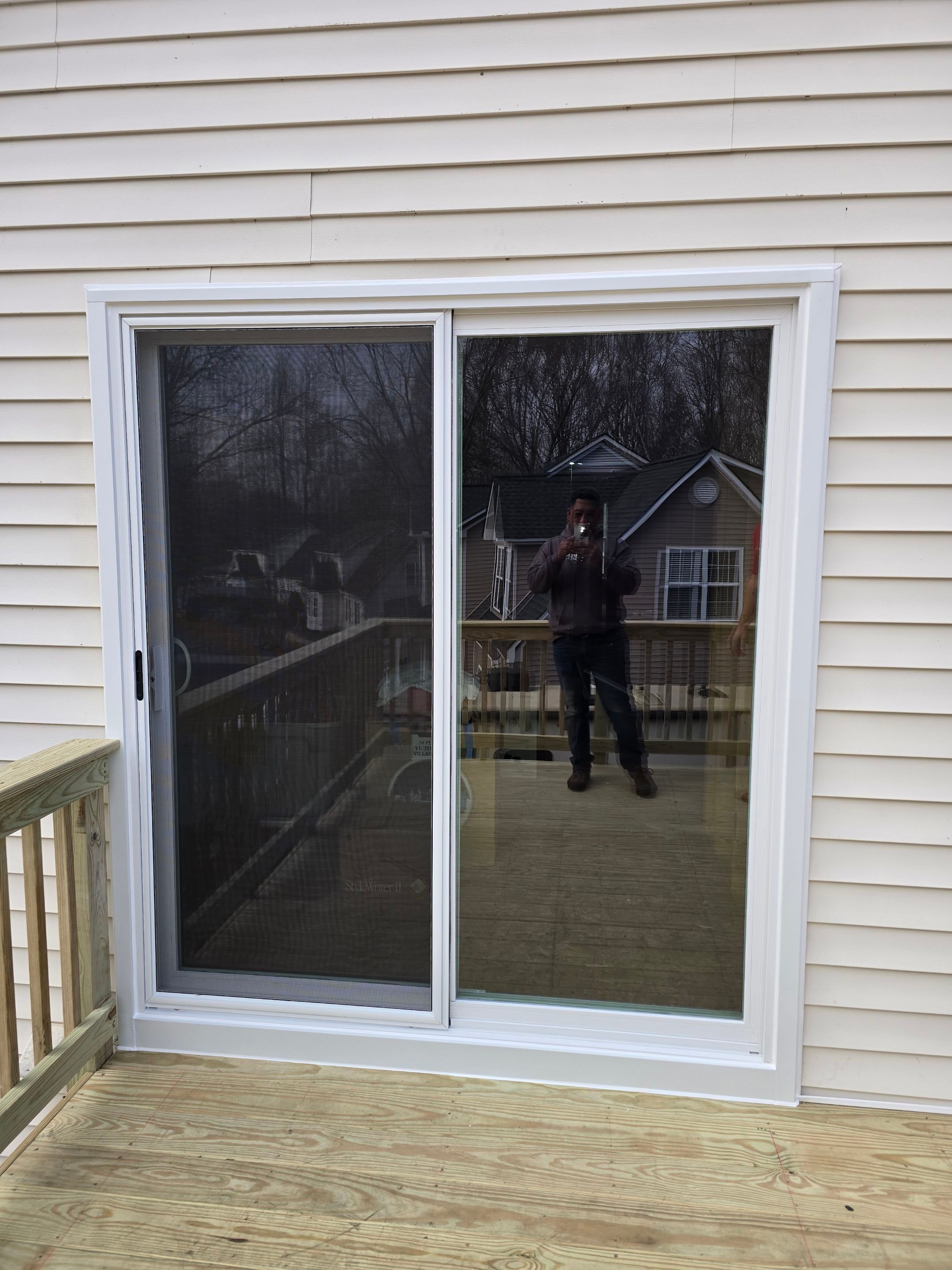 Elevated Pressure-Treated Wood Deck and Sliding Glass Door Installation in Clayton by The Remodeling Company