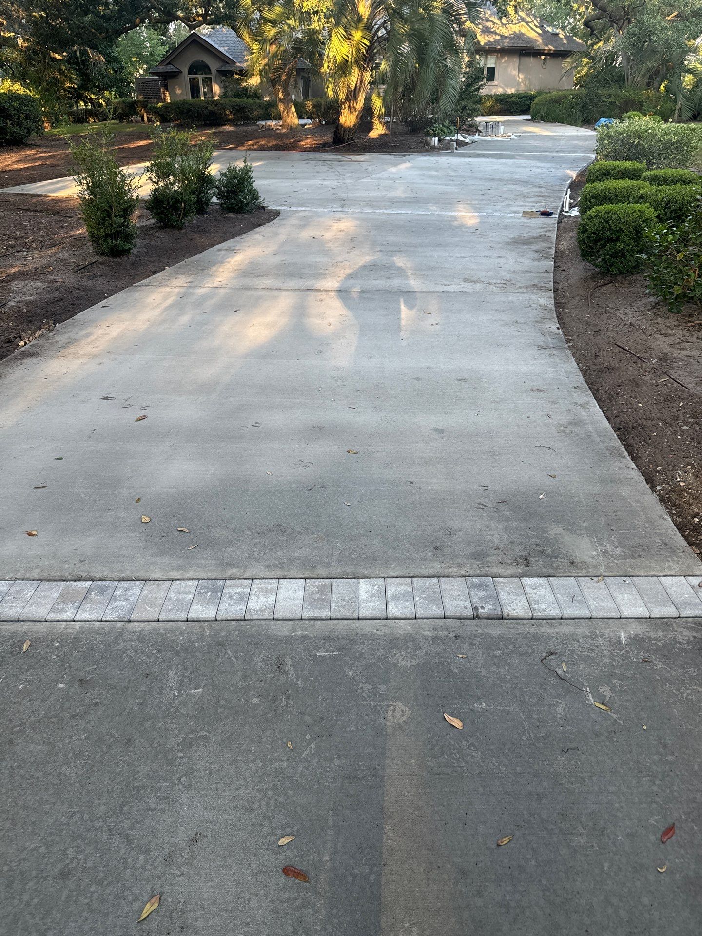 Custom Concrete Driveway with Decorative Paver Inlays in Hilton Head Island by Lowcountry Scapes, LLC