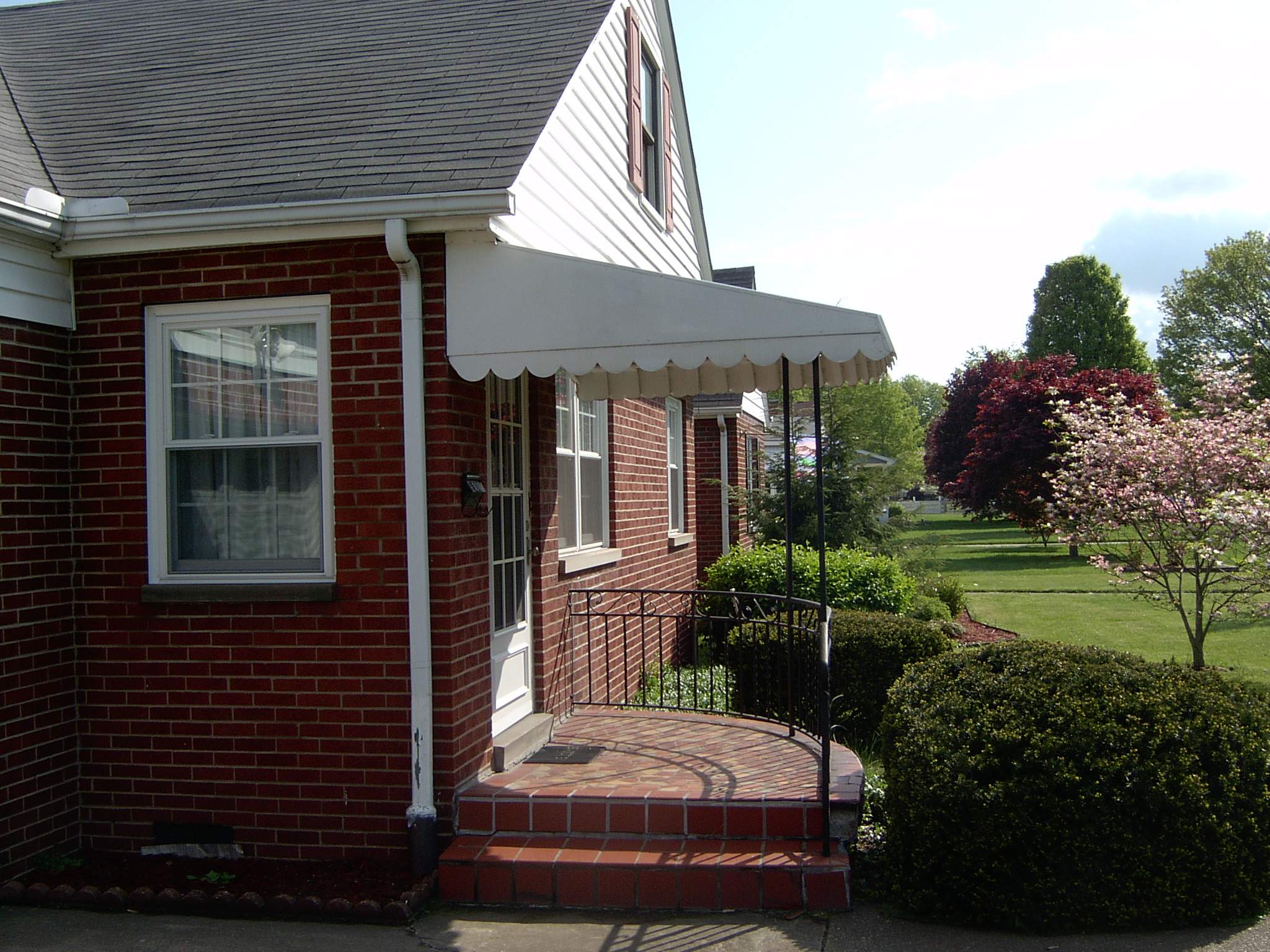 New front porch build, with tile floor and vinyl railing. by Secure Construction Company Inc