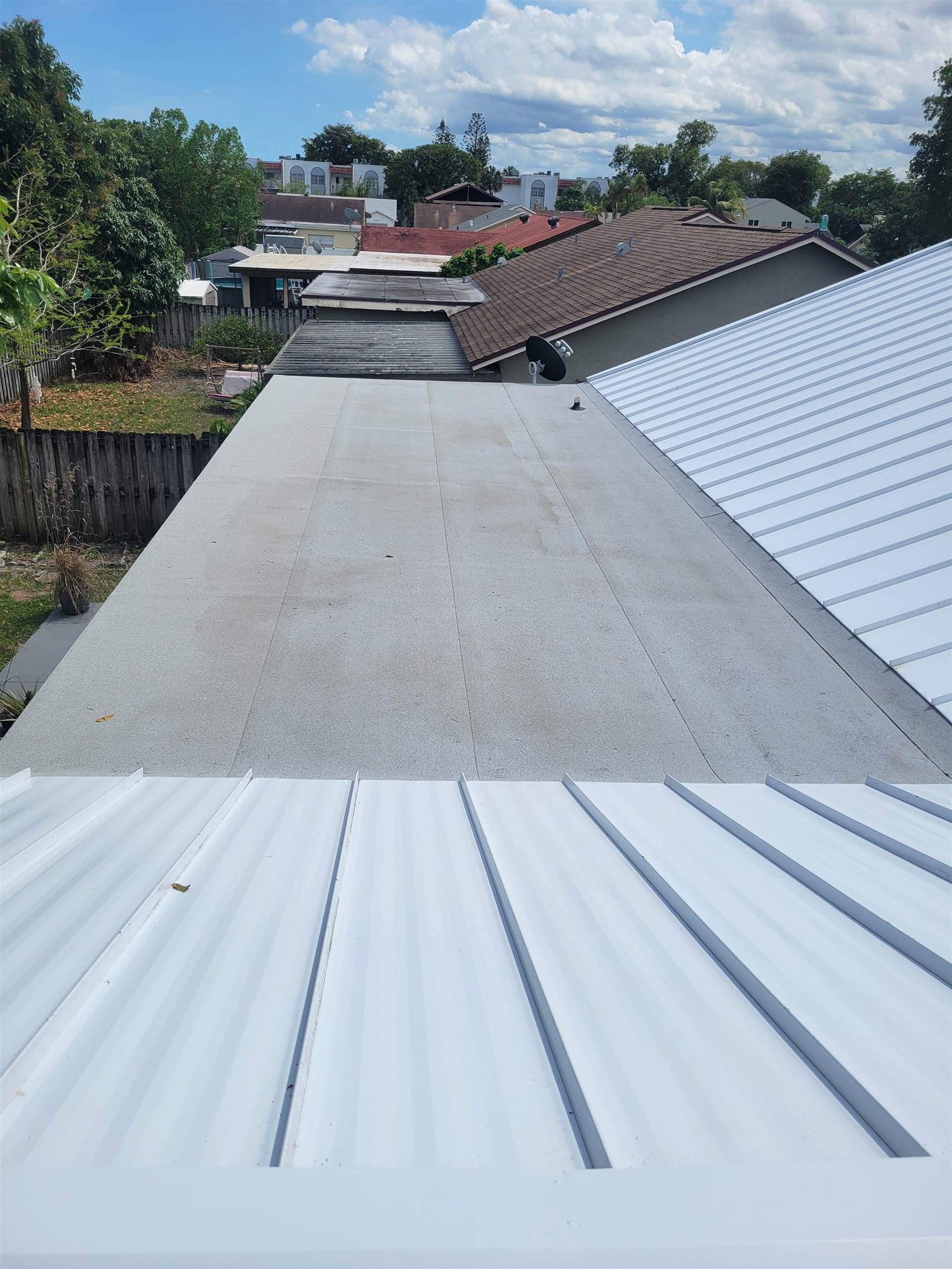 Standing Seam Metal & Flat Re-Roof using 1.5" Nail Strip 24ga Solar White Kynar Coated Standing Seam Metal Panels by Morton Roofing, Inc.