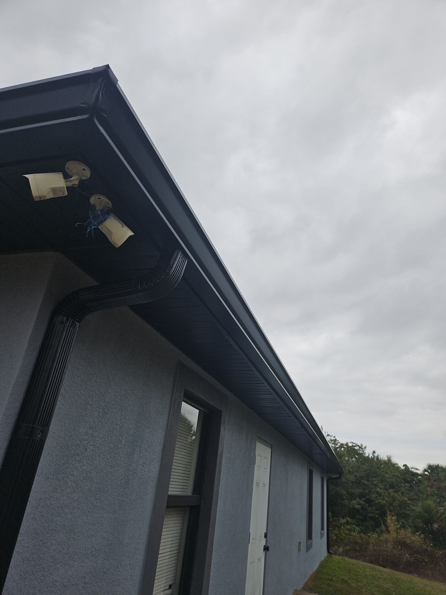 Black Seamless Gutters & Soffit/Fascia in Lehigh Acres FL by Gutter Professors