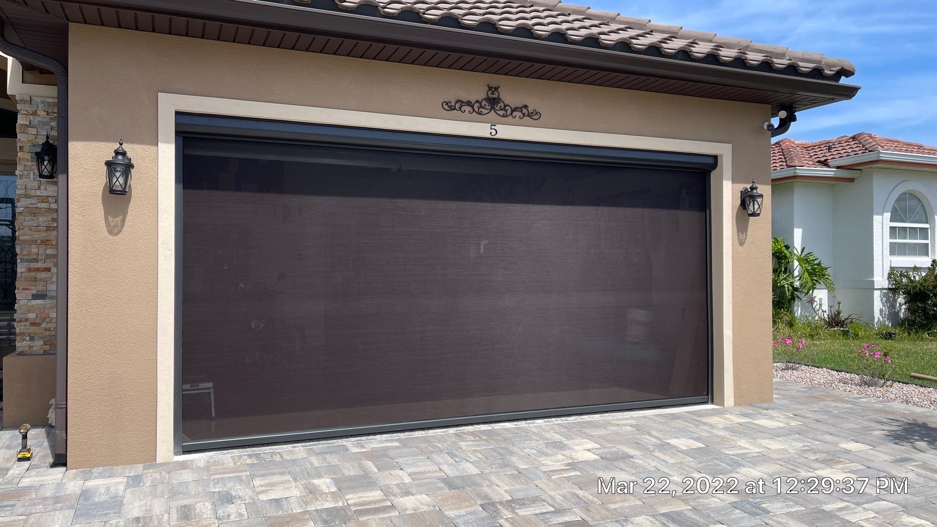Bronze rolling screen with hurricane fabric by Smart Guard Shutters