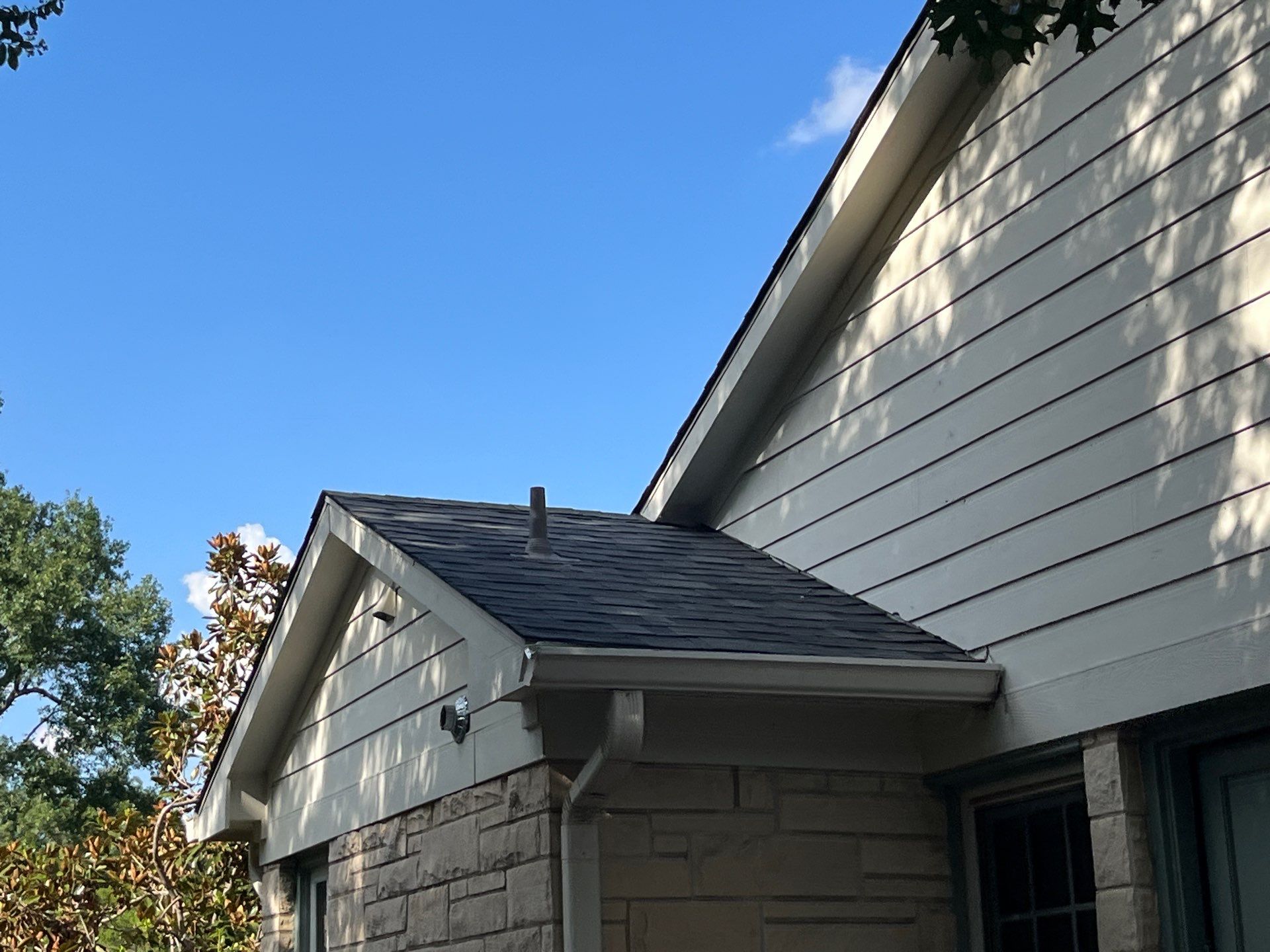 White brick with Malarkey Storm Grey by Tejas Roofworks + Restoration