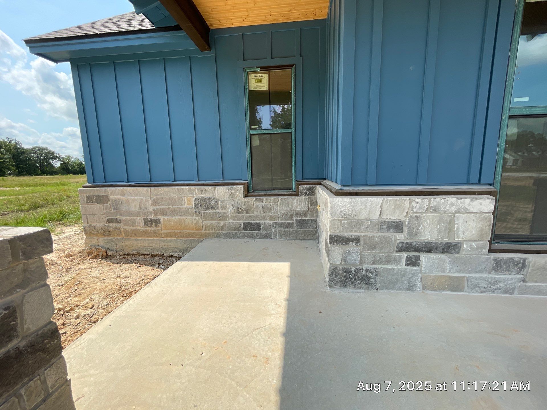 Natural Stone Elegance: Apex Installation Accented by Blue Siding by Apex Conventional Stucco Llc