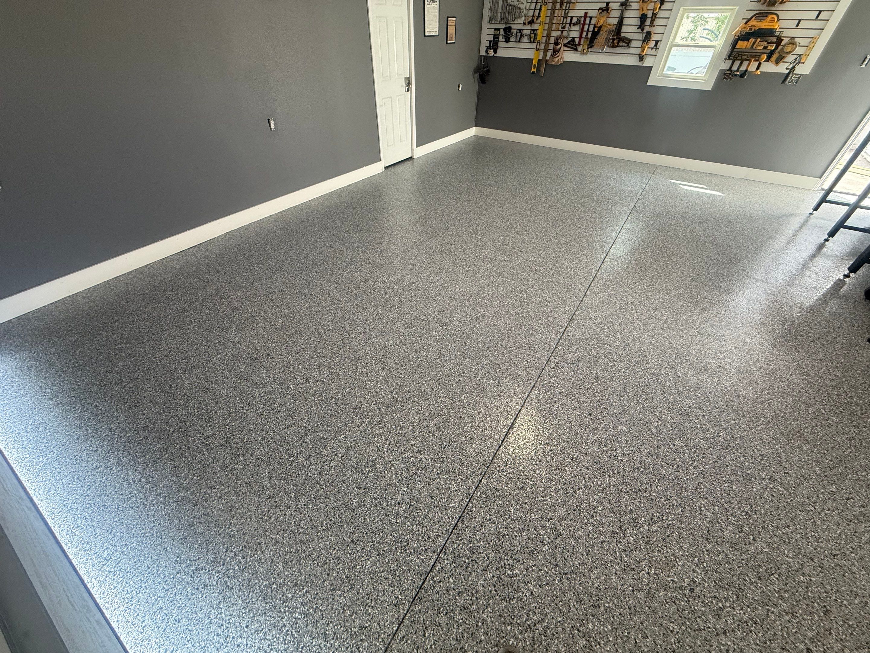 Custom Garage Floor Coating and Backyard Patio Refinishing in Tyndall by Select Painting, Coatings & Garage Cabinets