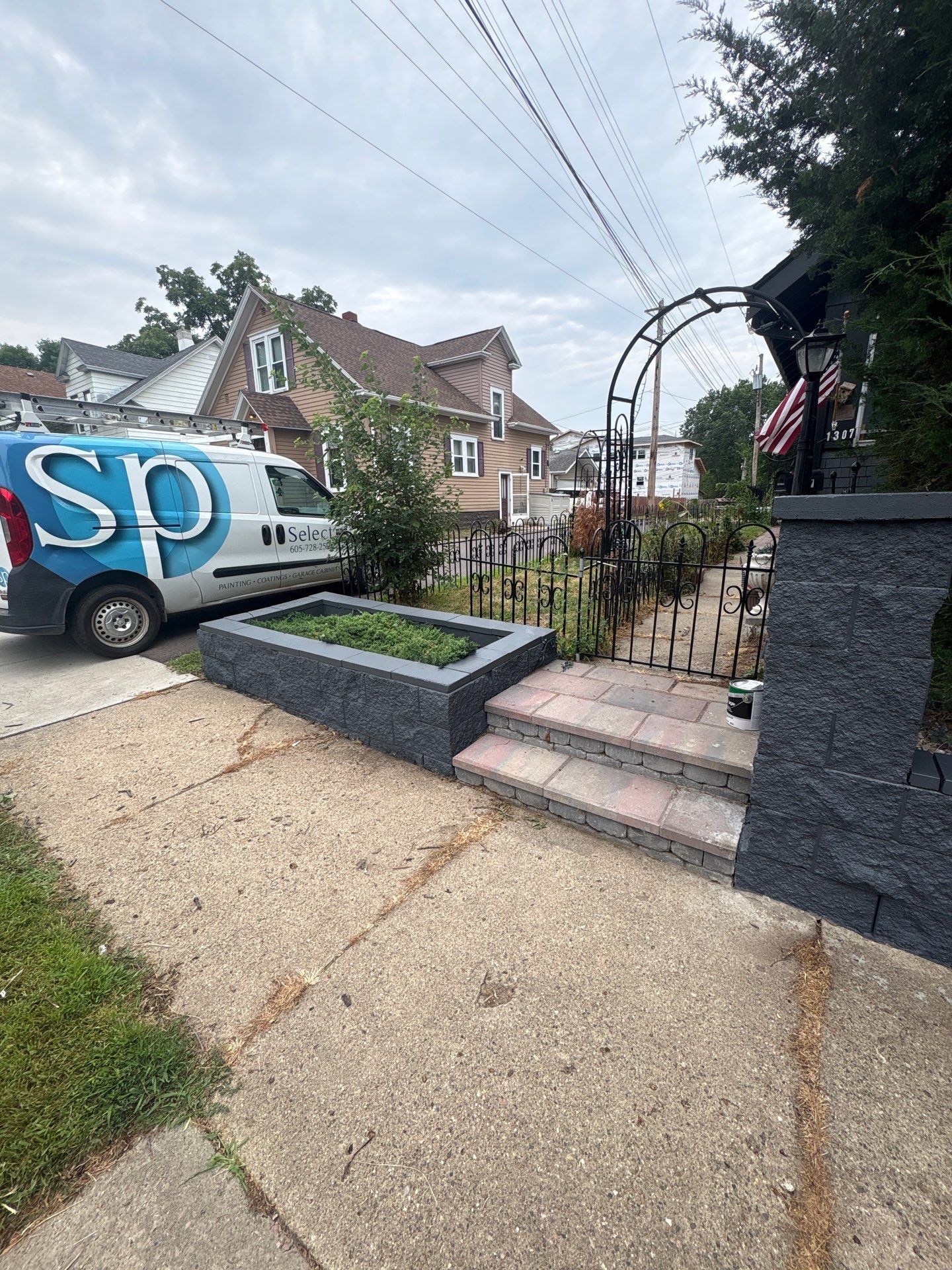 Exterior Masonry Painting for a Sioux Falls Retaining Wall by Select Painting, Coatings & Garage Cabinets