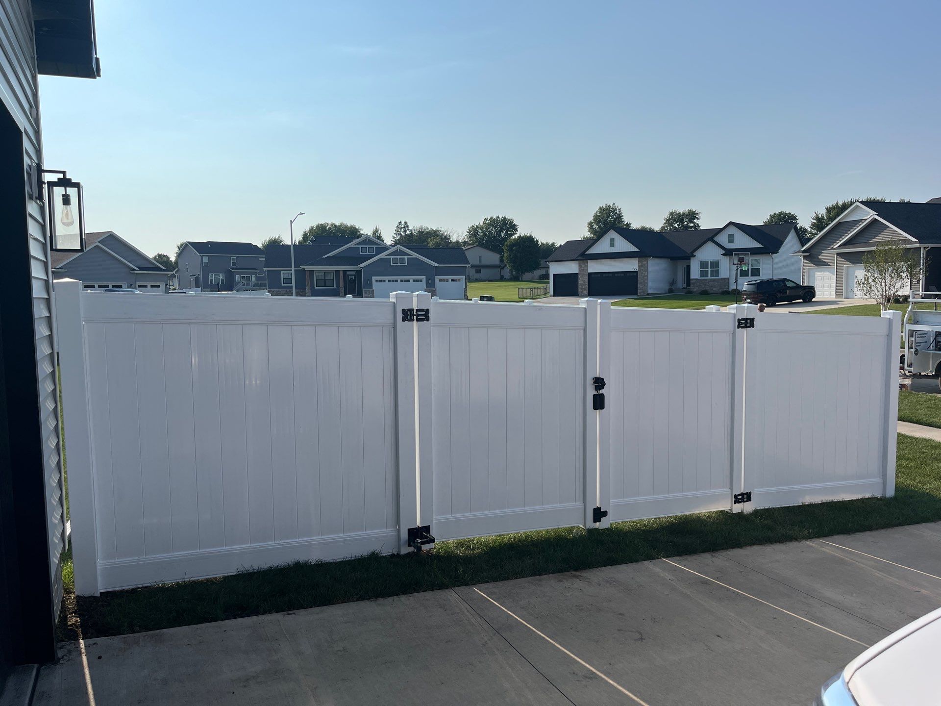 White Vinyl Privacy Fence Installation With Double Gates in Waterloo by Perfect Picket Fence and Stain